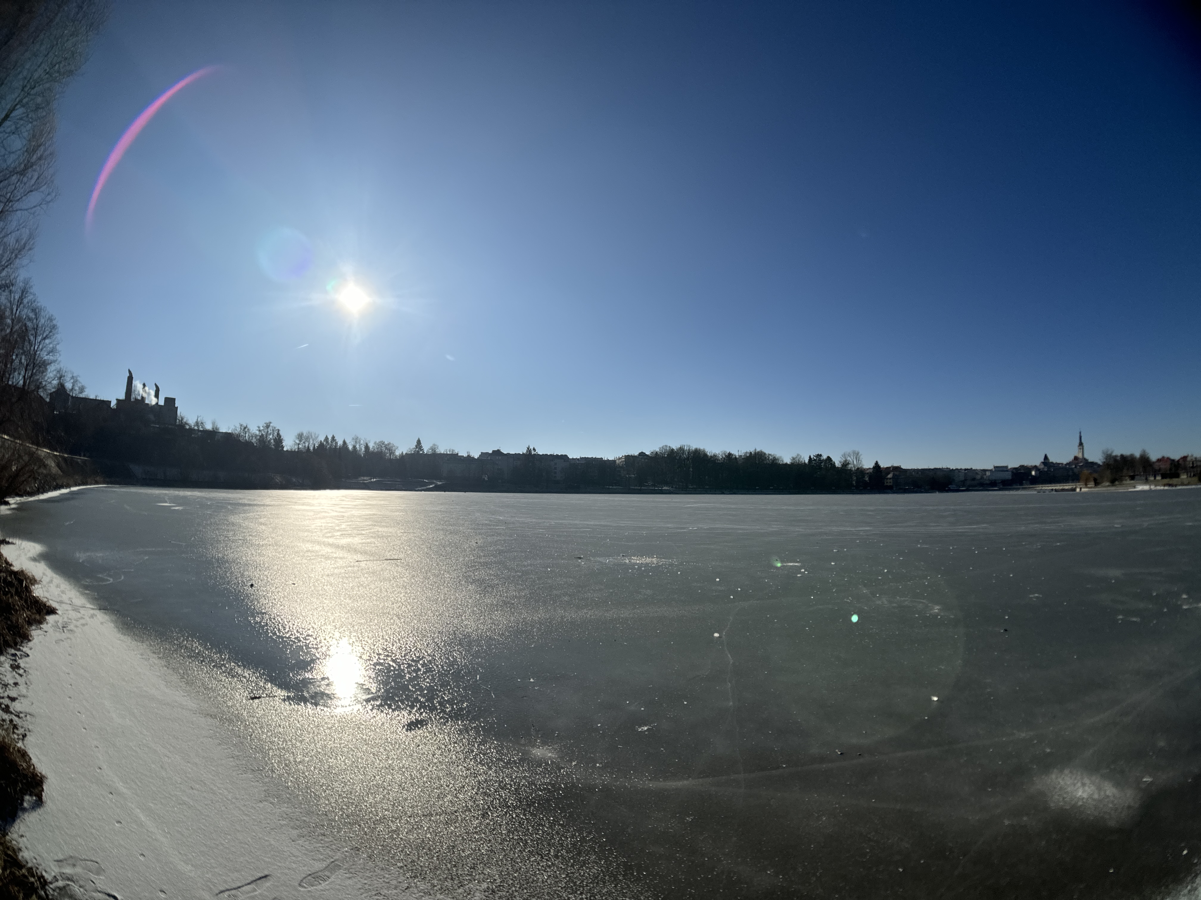 sun over frozen lake