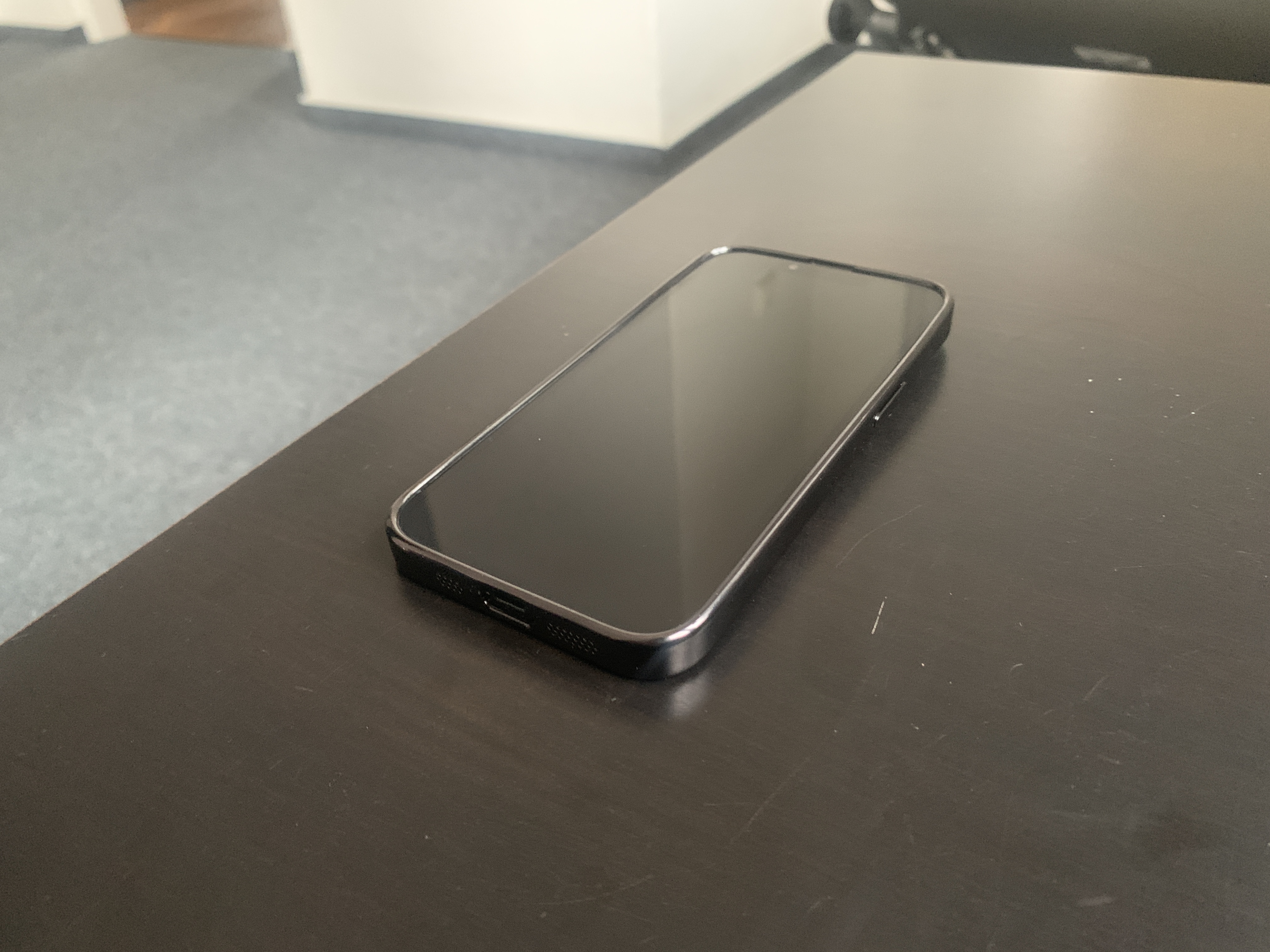 black smartphone on table