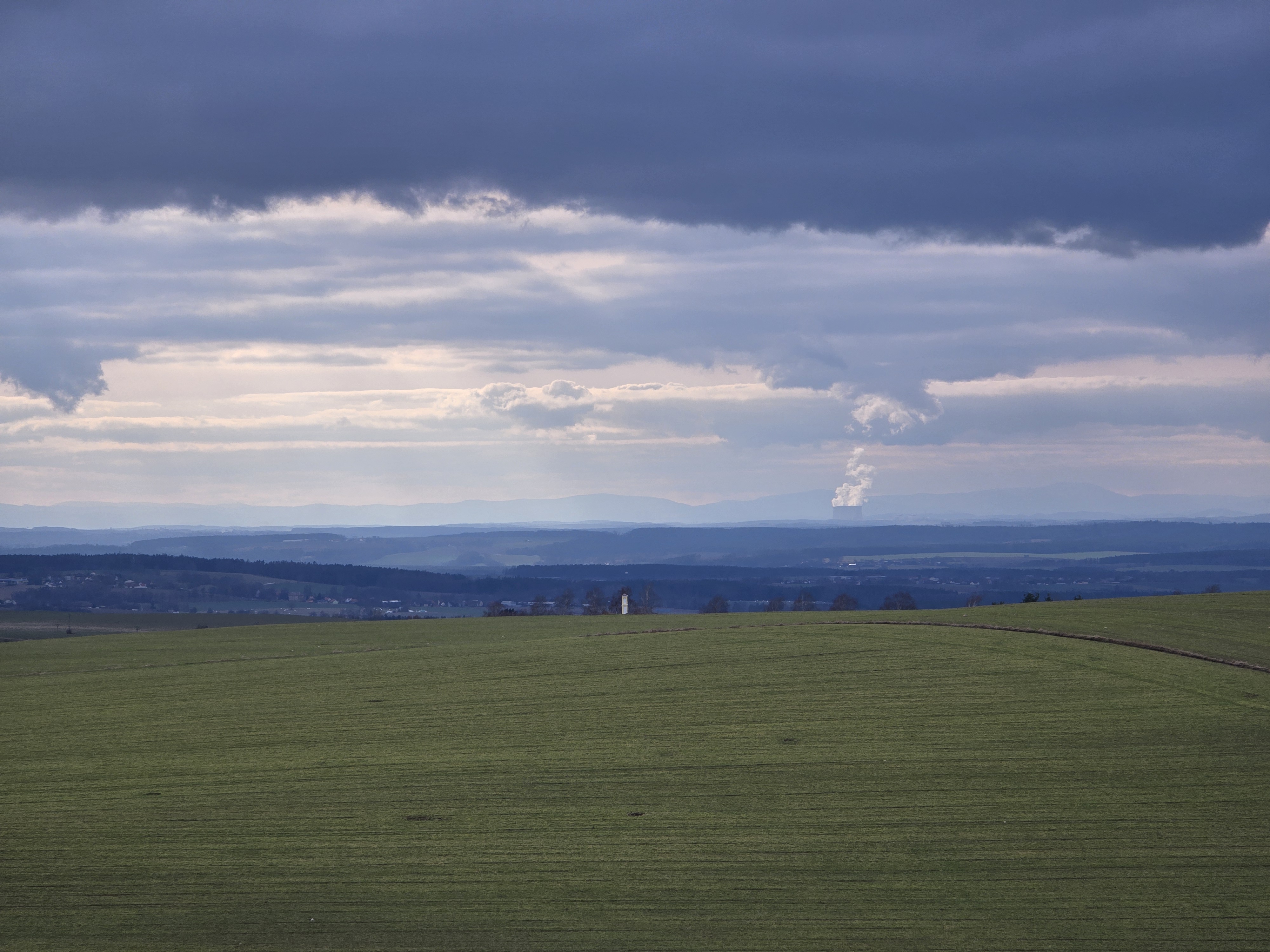 expansive field distant smoke