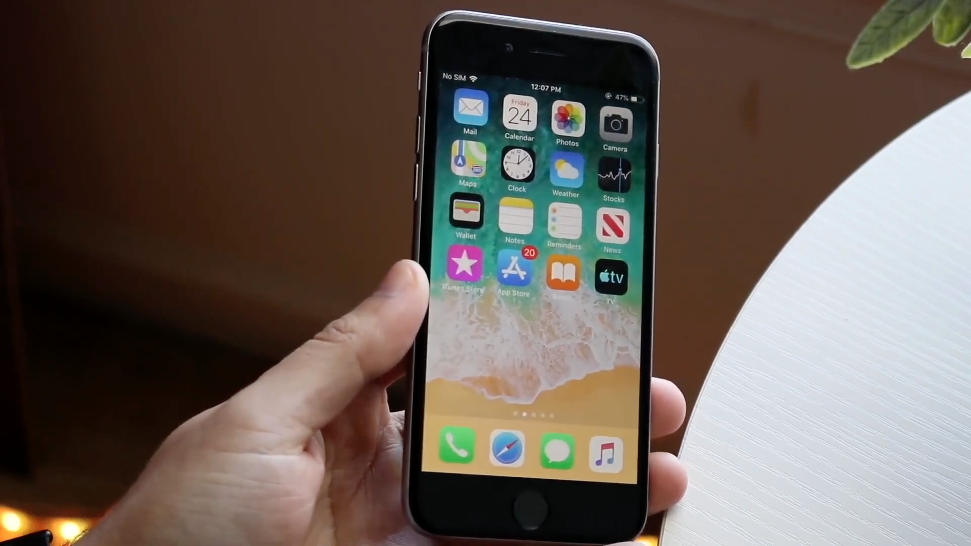 hand holding smartphone home screen