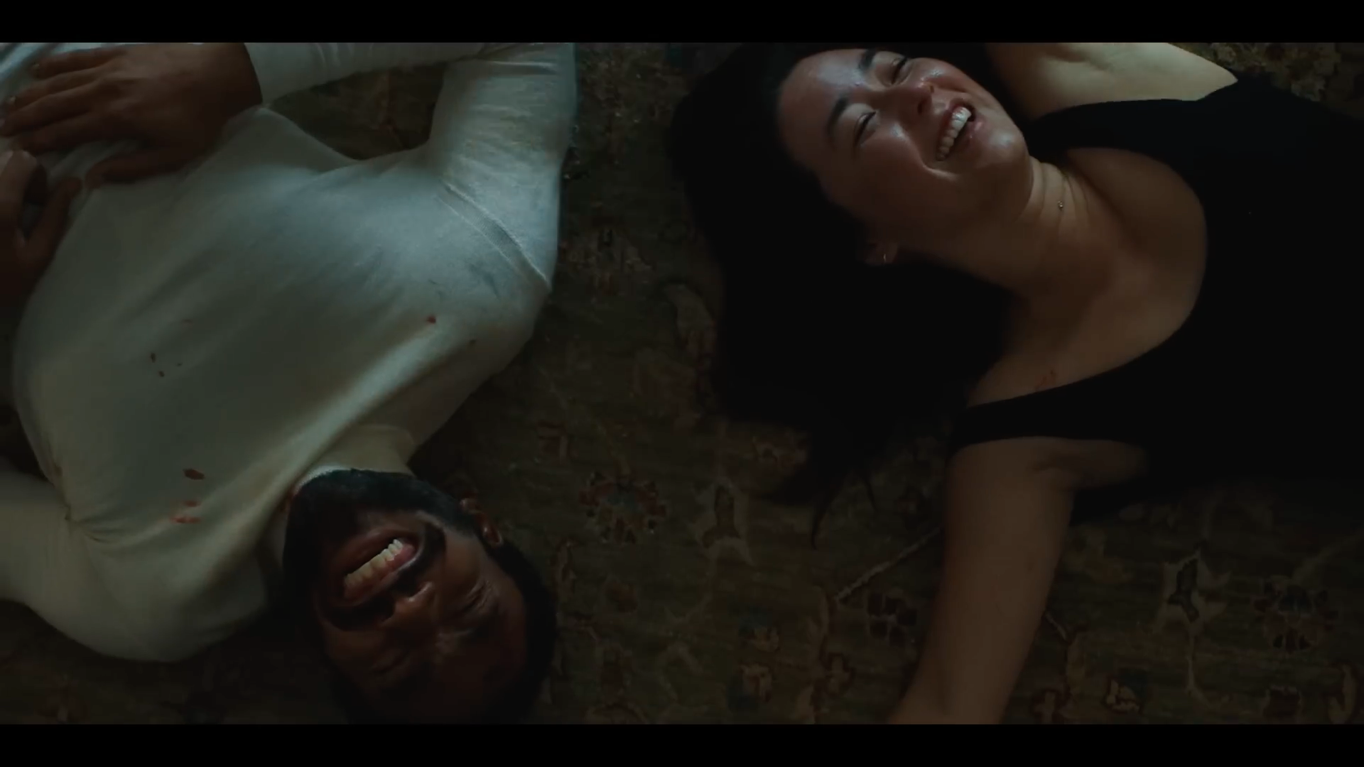 man and woman laughing floor