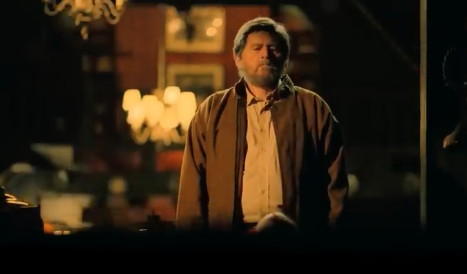 man standing dimly lit room