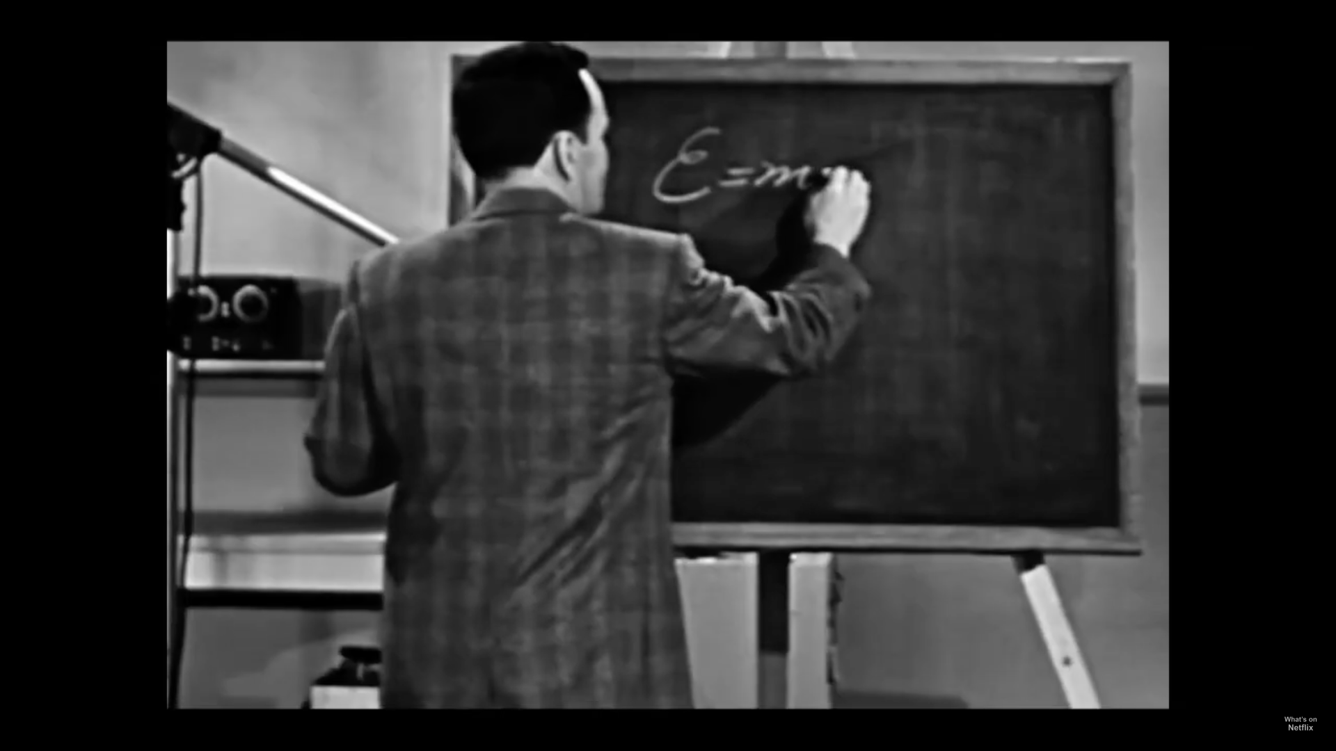 man writing on chalkboard