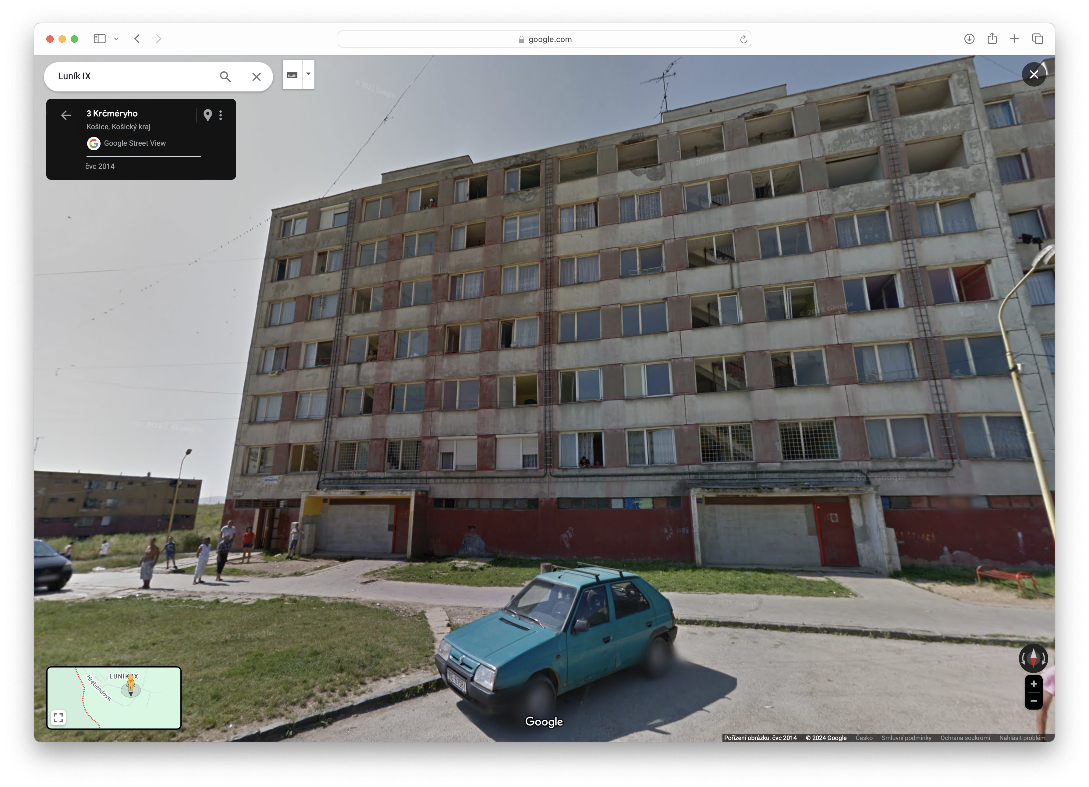 old apartment building with car