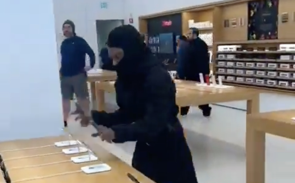 people in store examining phones