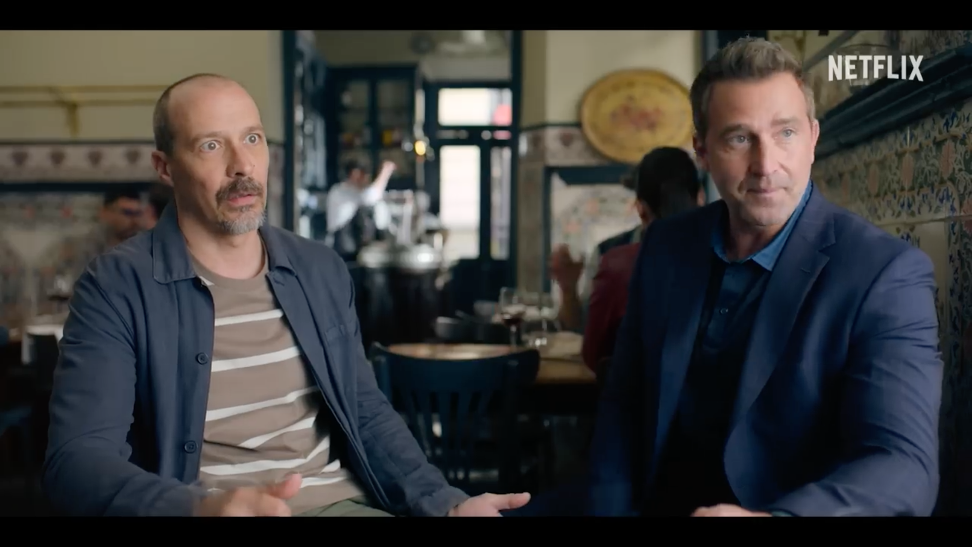 two men sitting in restaurant