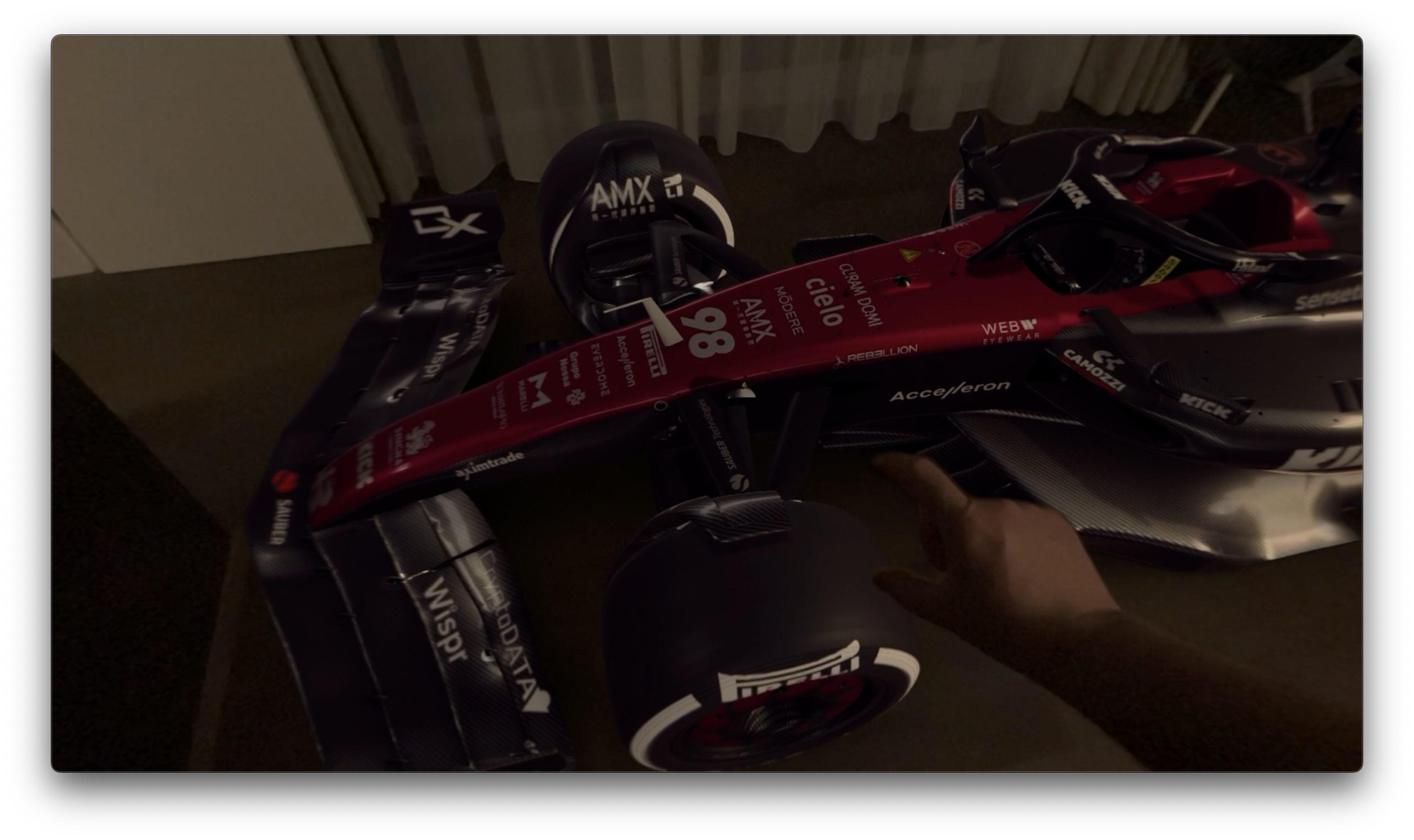 hand pointing at race car