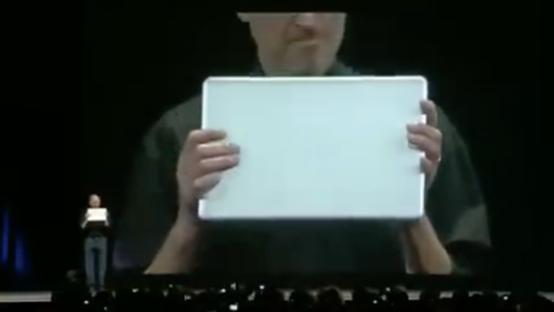 person holding laptop on stage