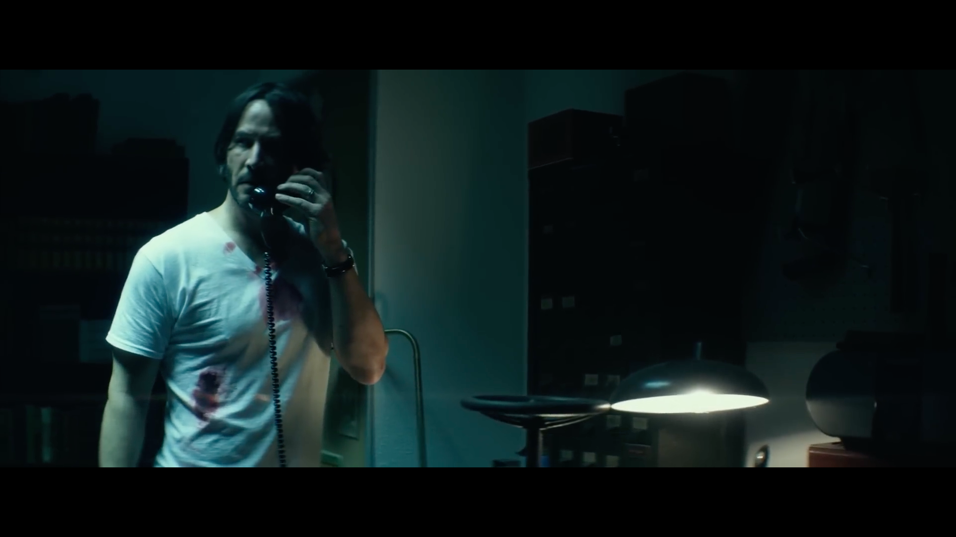 person on phone in dark room