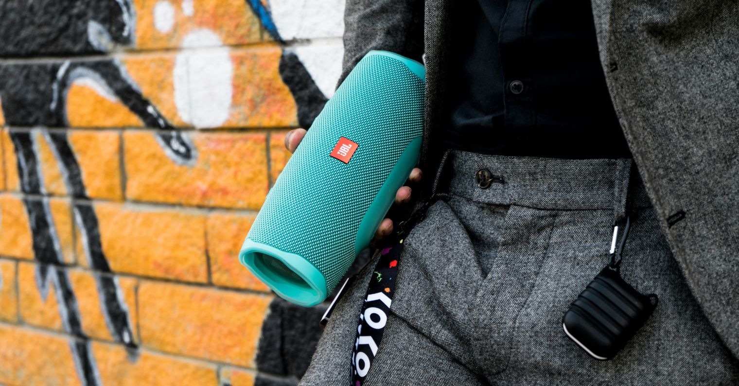 man holding jbl speaker