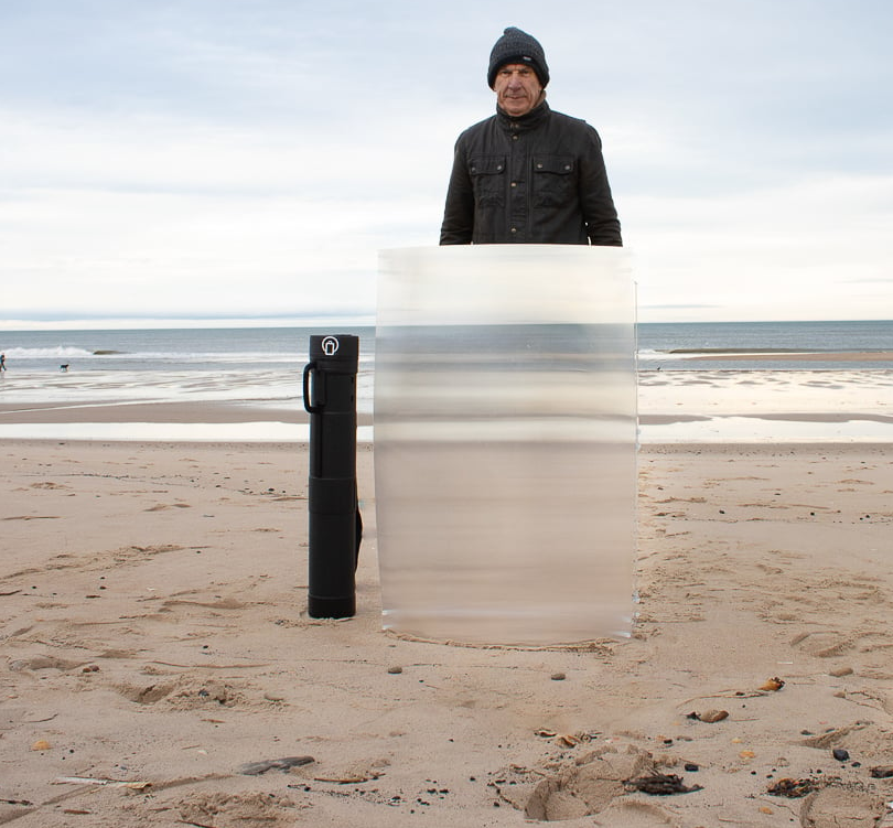 man with invisibility shield on beach