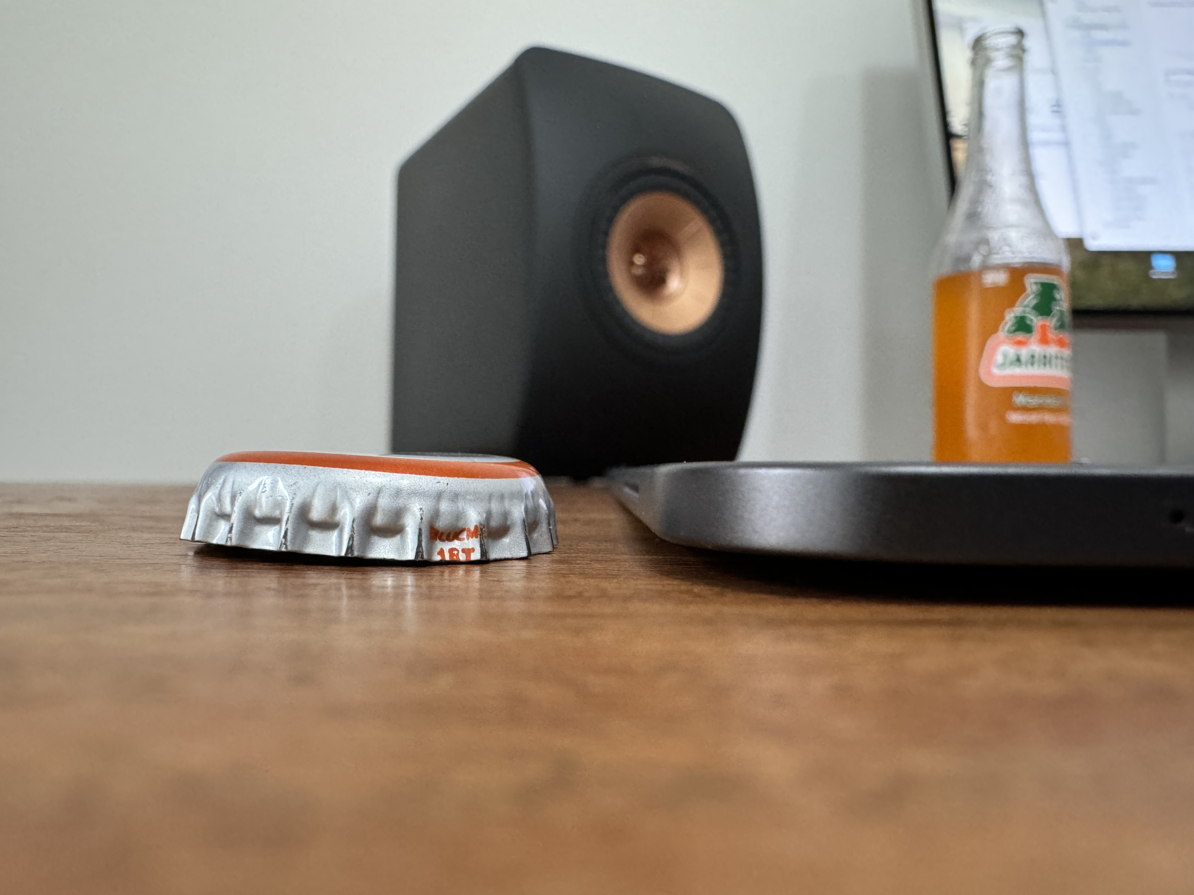 bottle cap speaker tablet on desk
