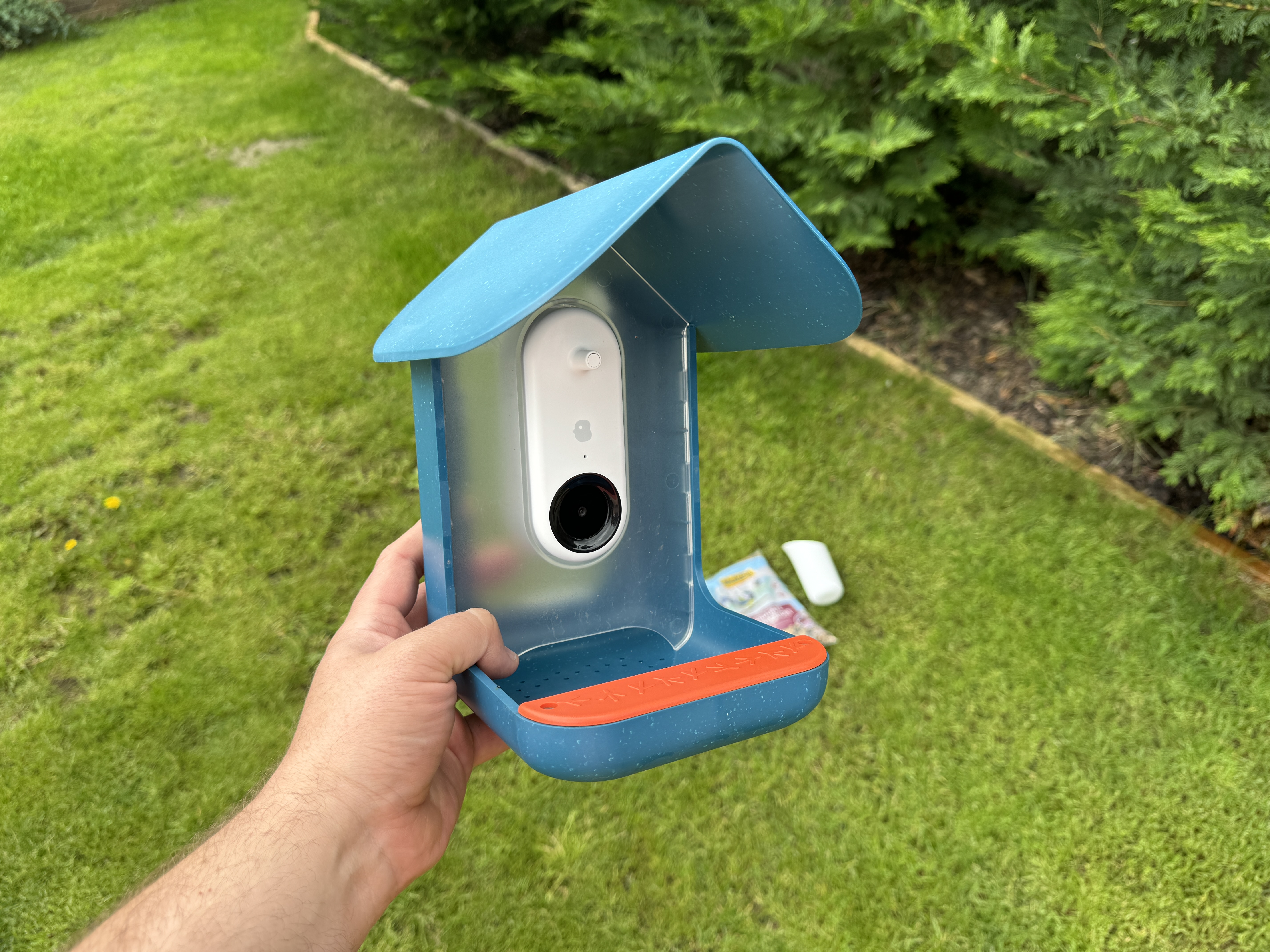 hand holding birdhouse camera