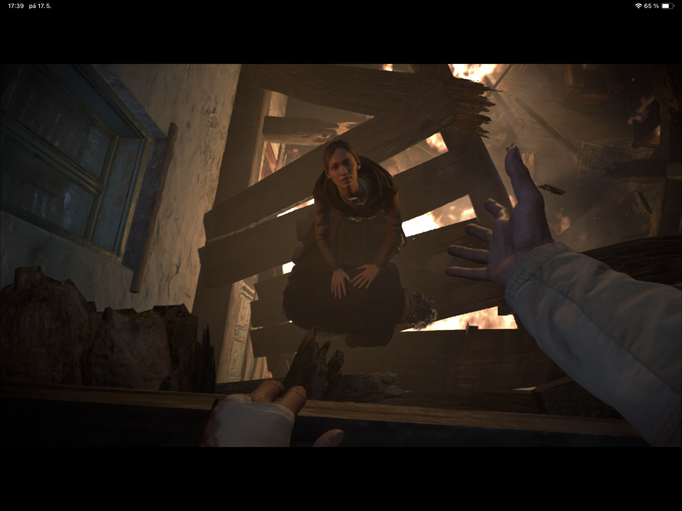 person reaching out in burning building