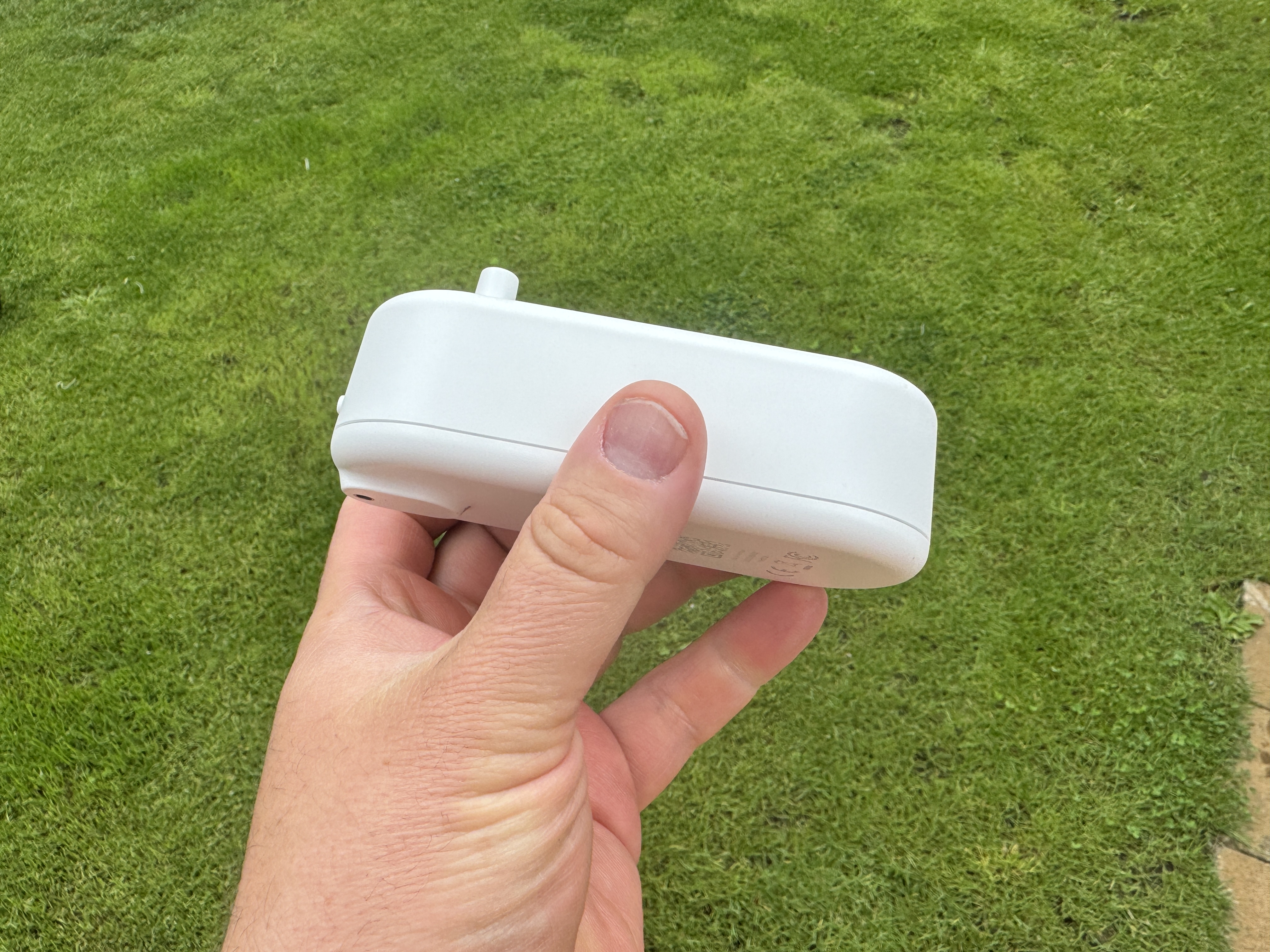 side view white device on grass