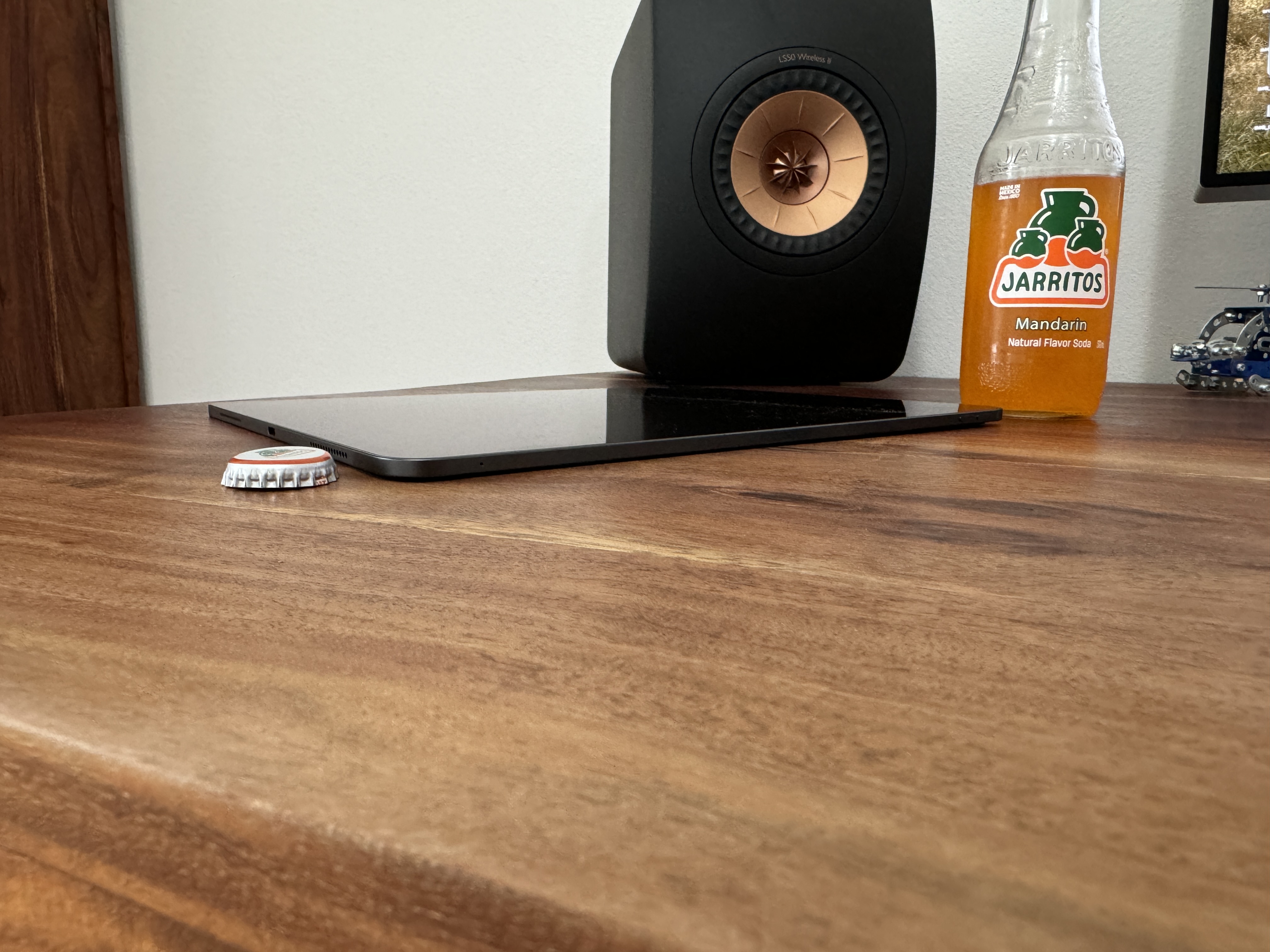 tablet speaker jarritos on wooden desk