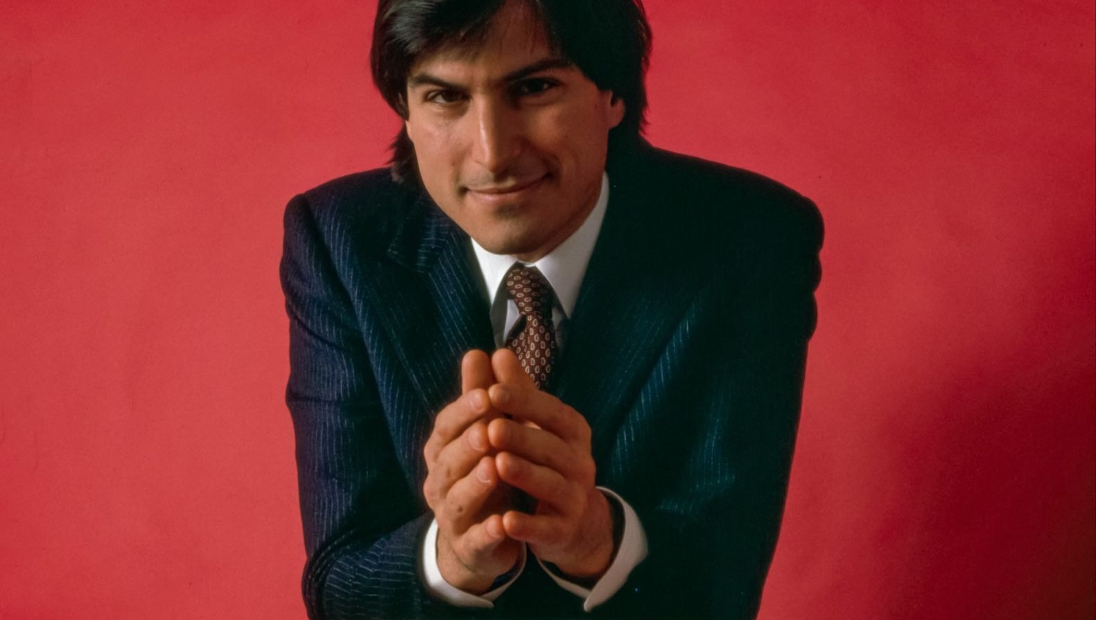 man in suit red background