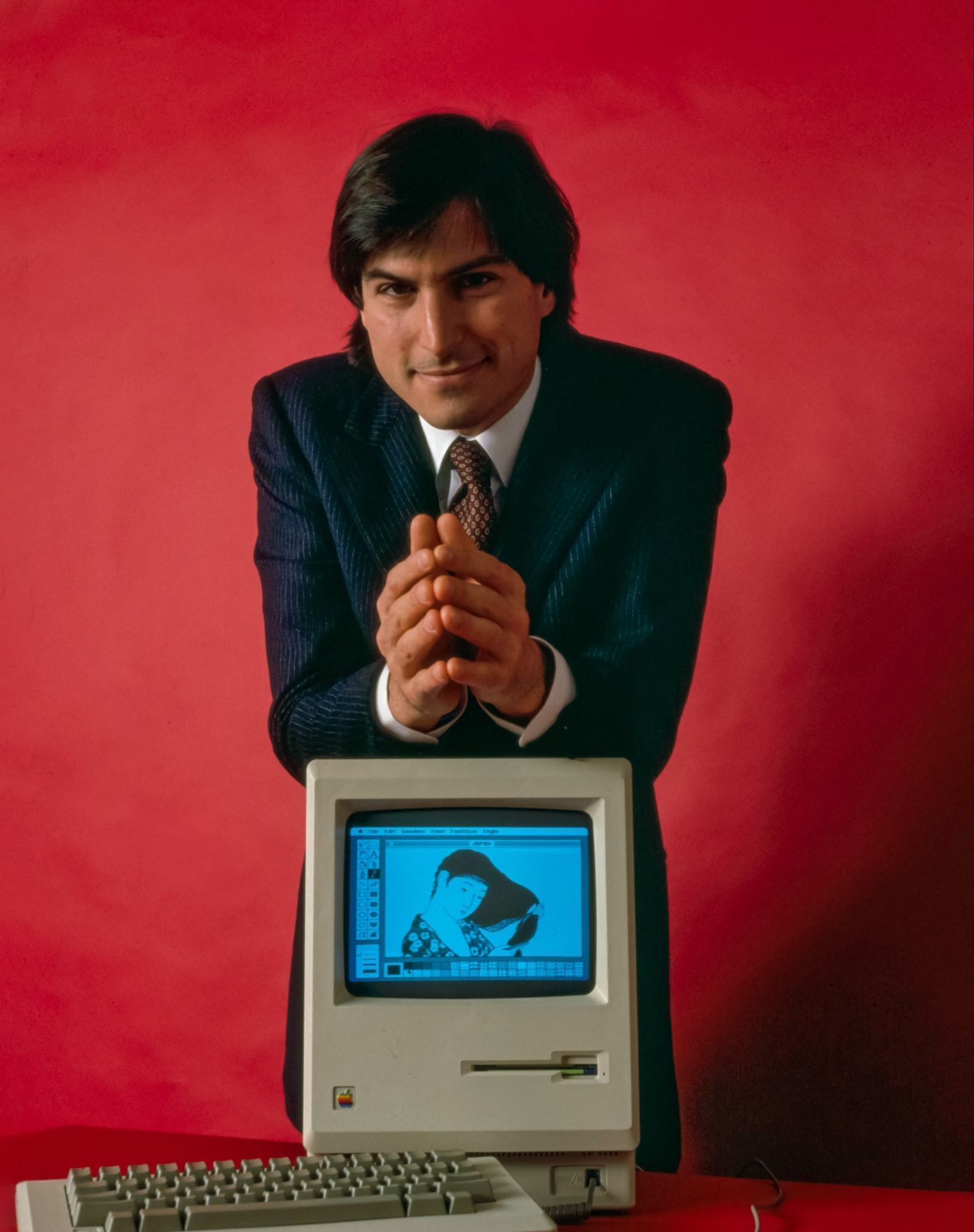man with macintosh computer