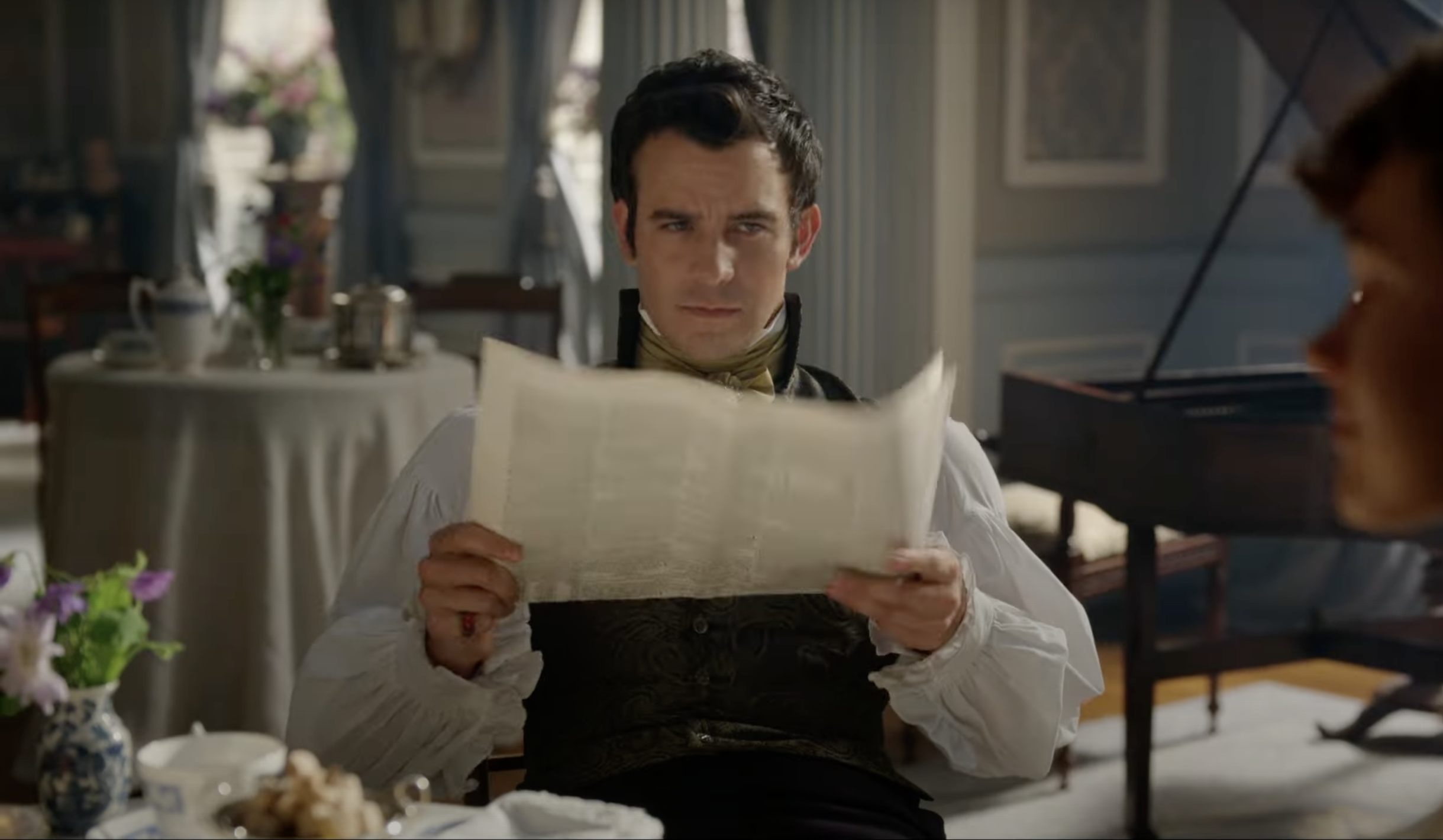 man reading newspaper in period costume