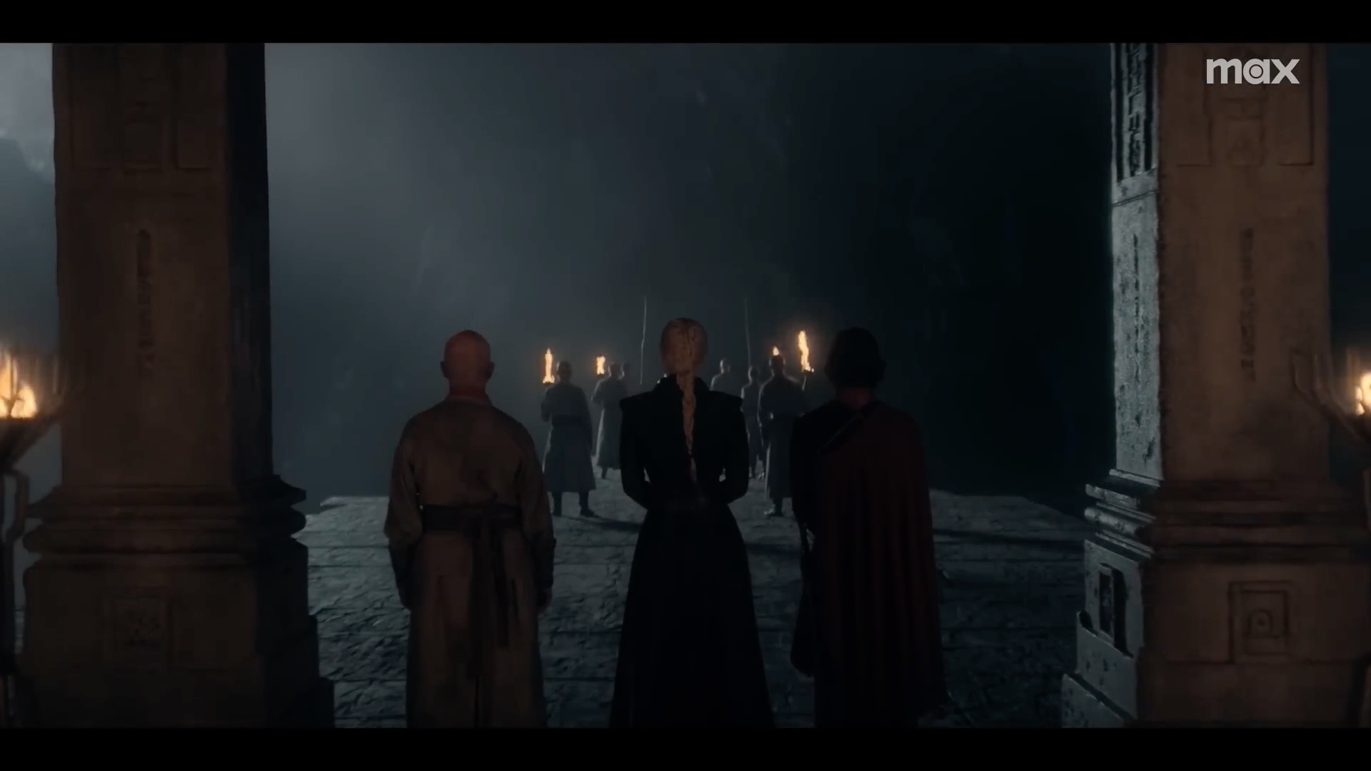 people standing in dark cave