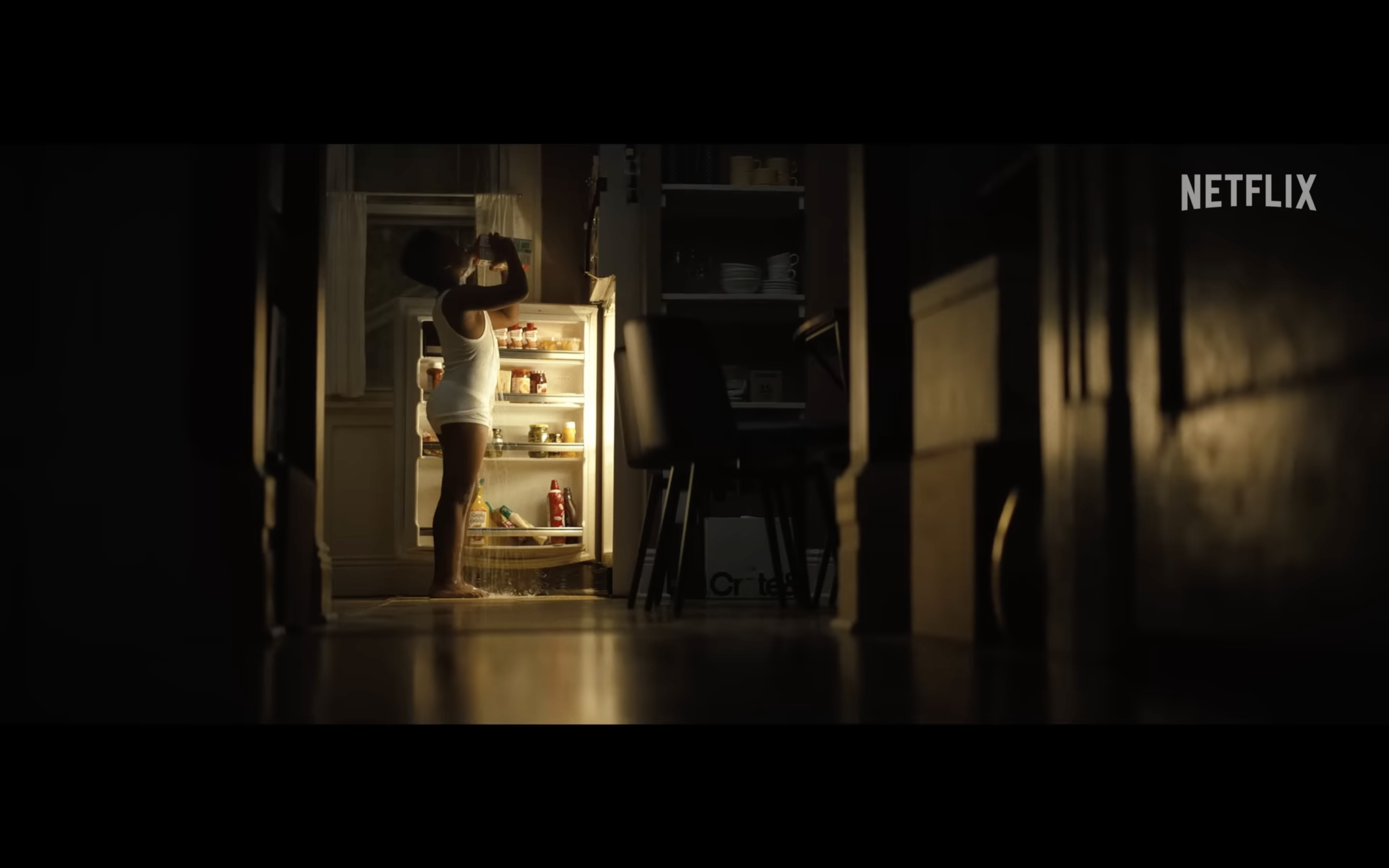 child standing at fridge