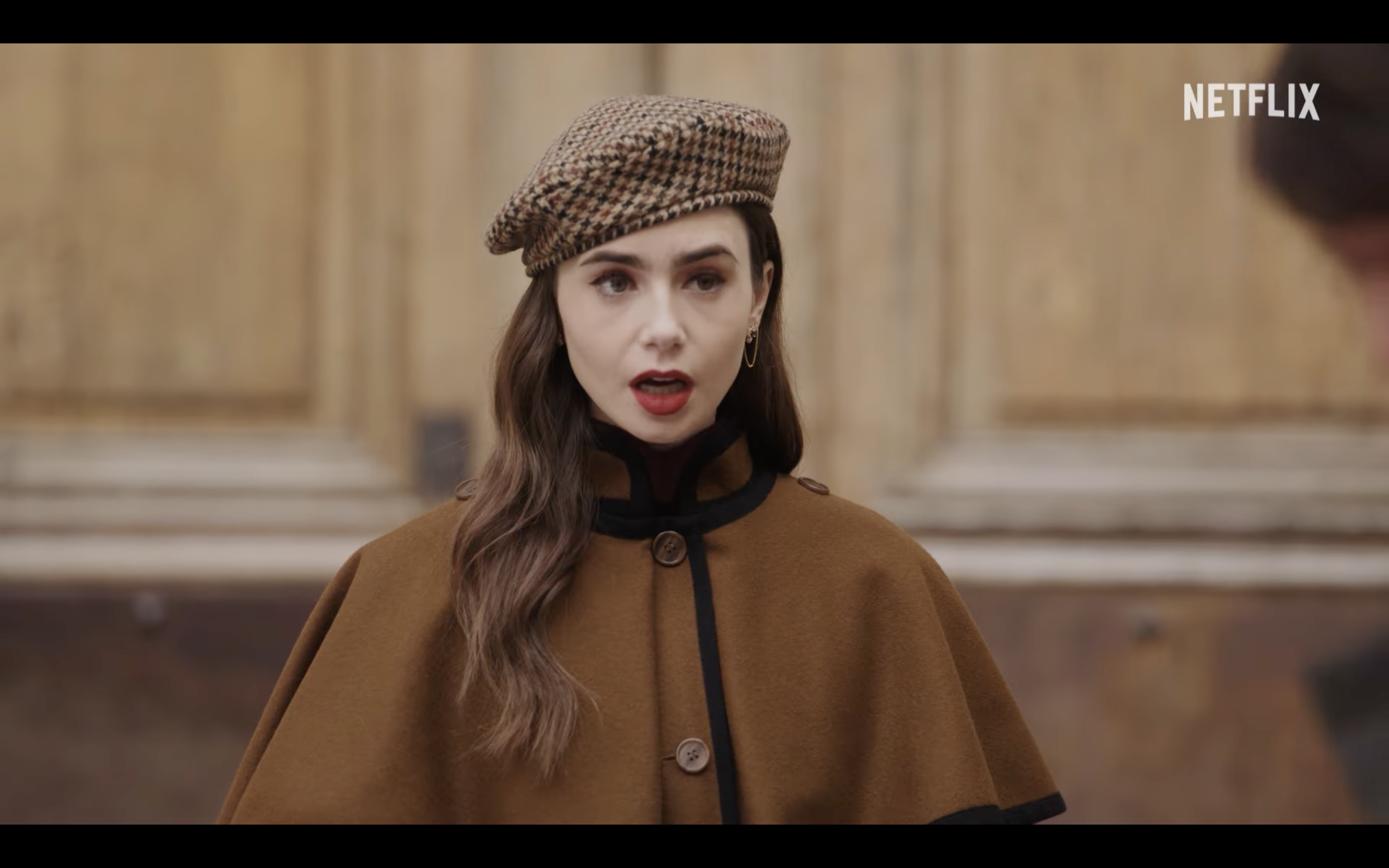 person in brown coat and beret