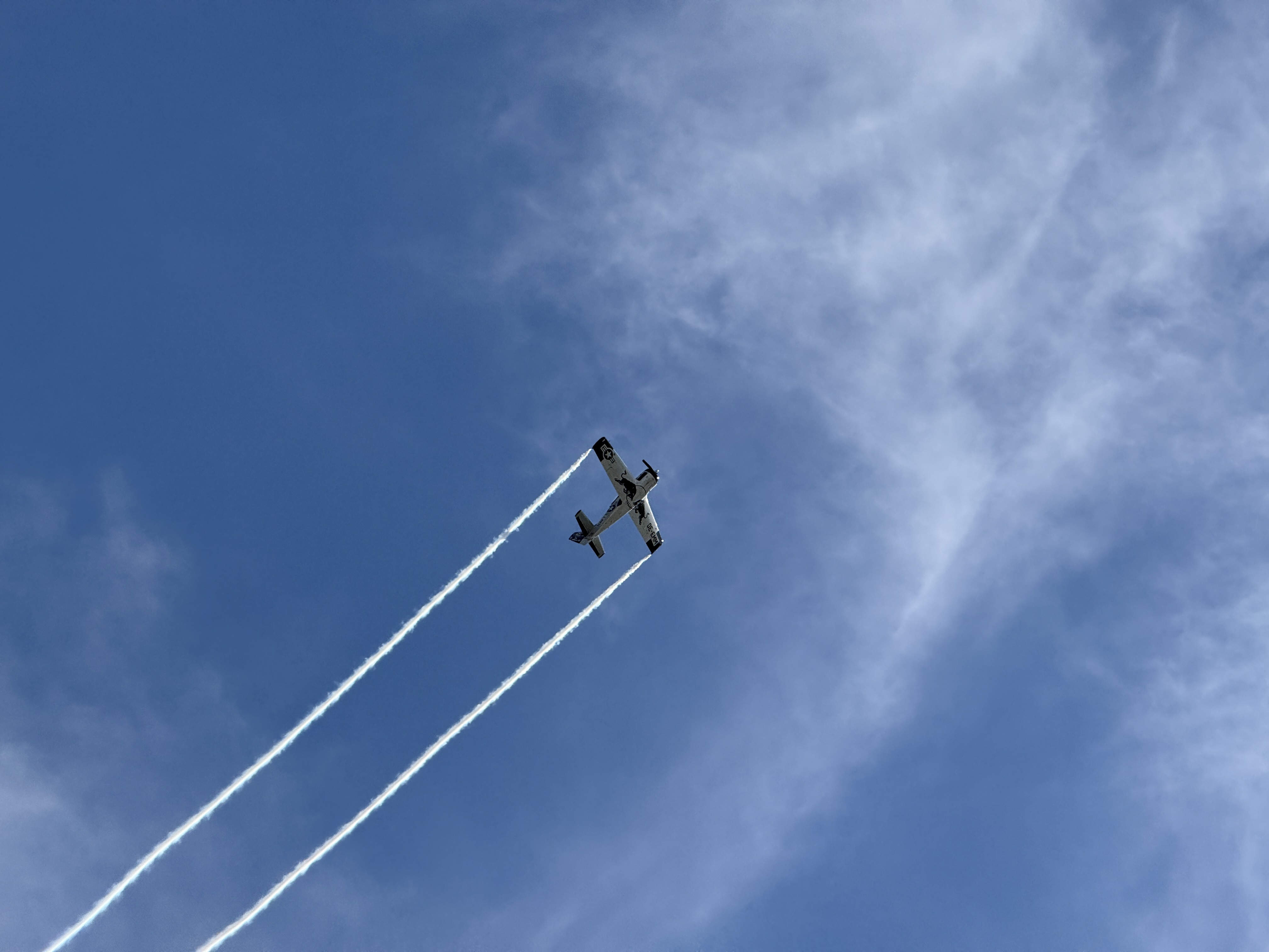 airplane in sky with trails