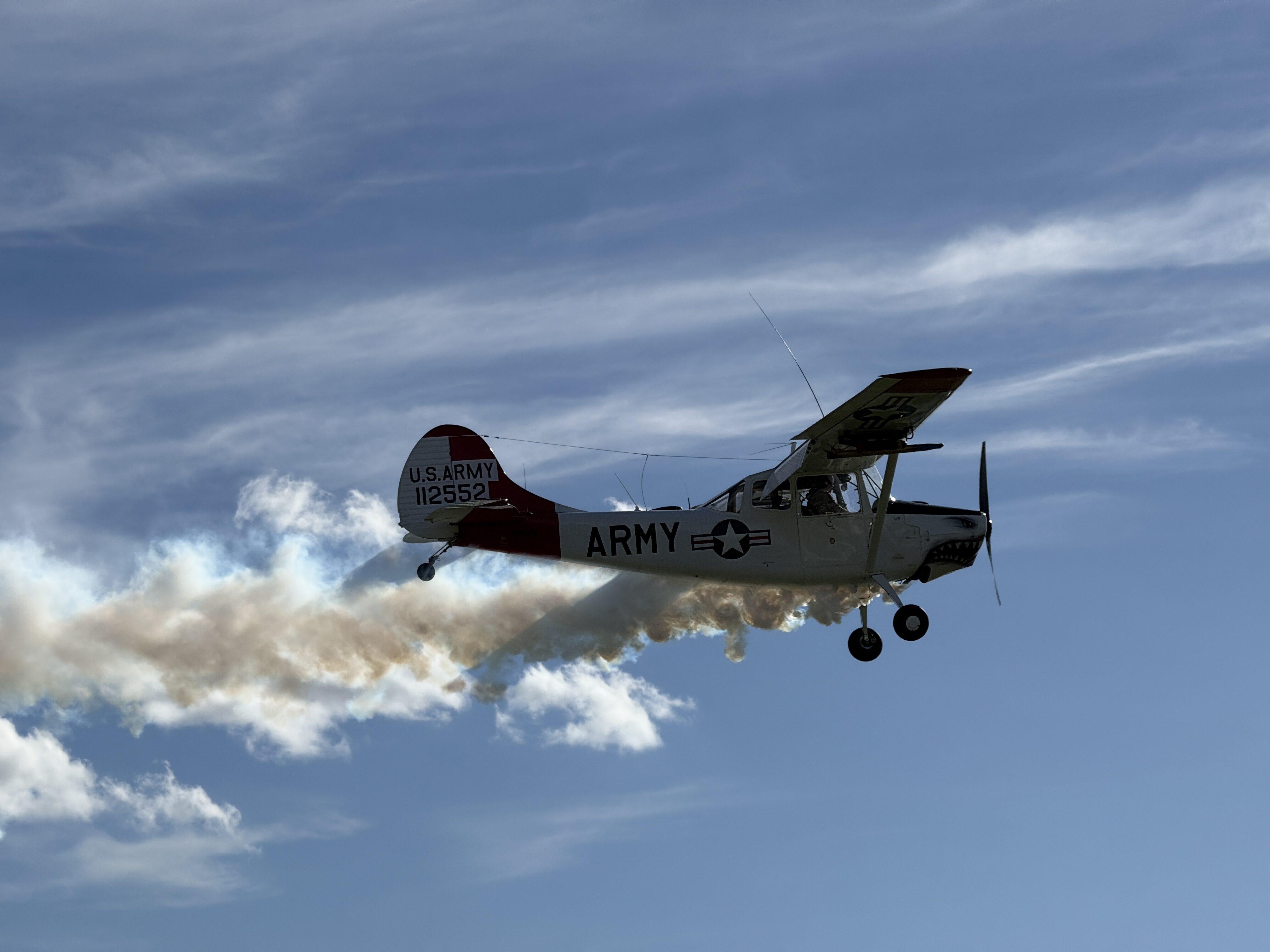 army airplane flying smoke
