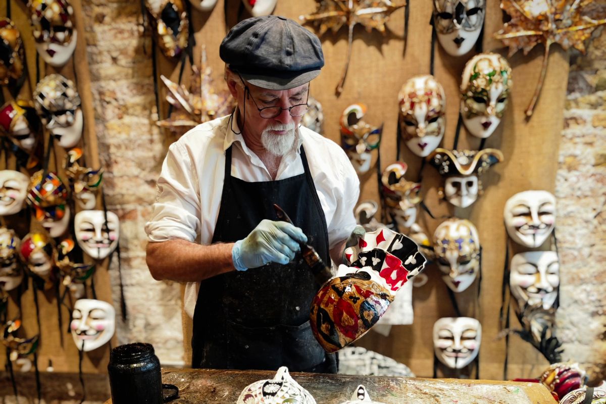 artist painting venetian mask