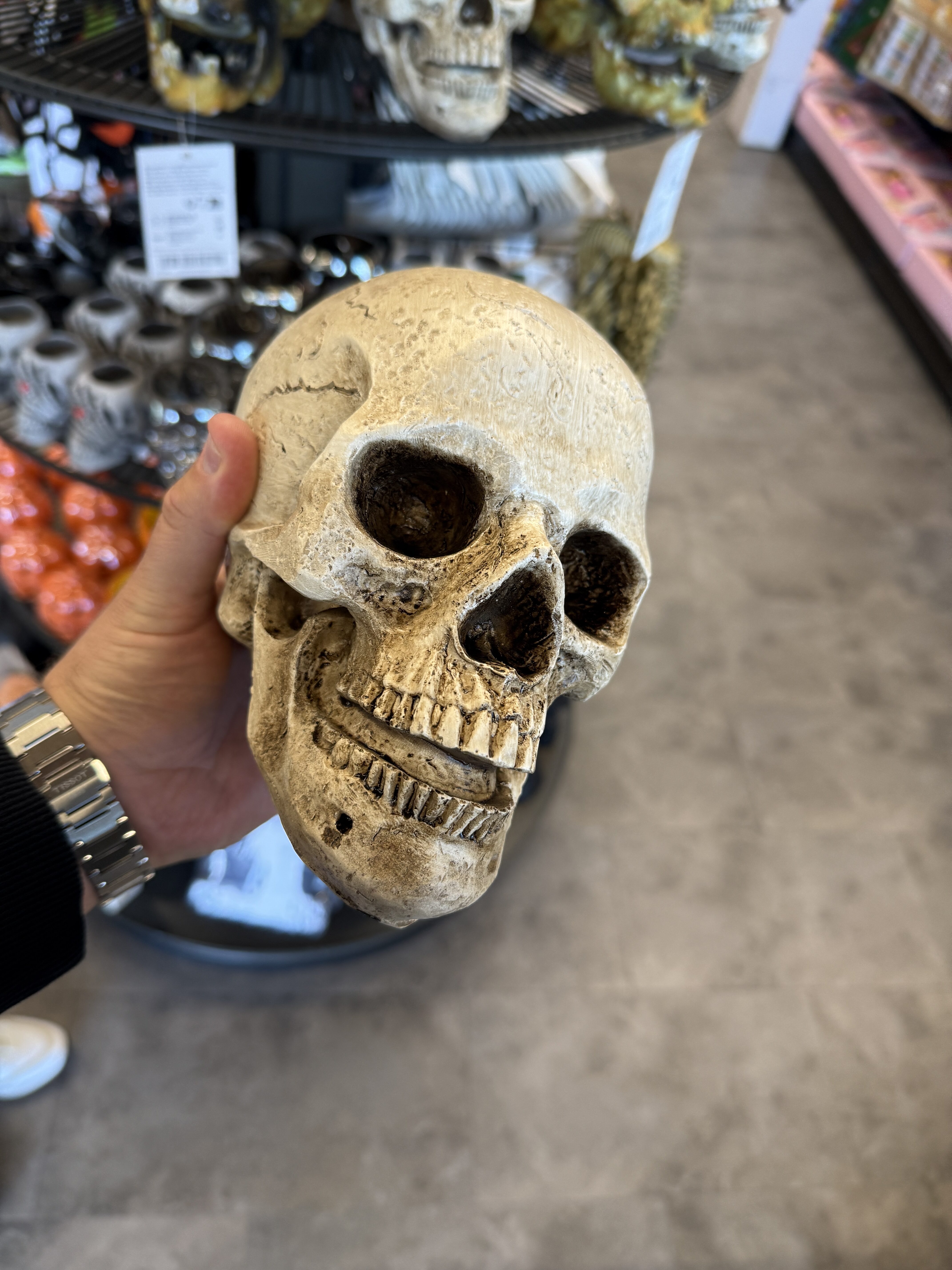 hand holding skull decoration