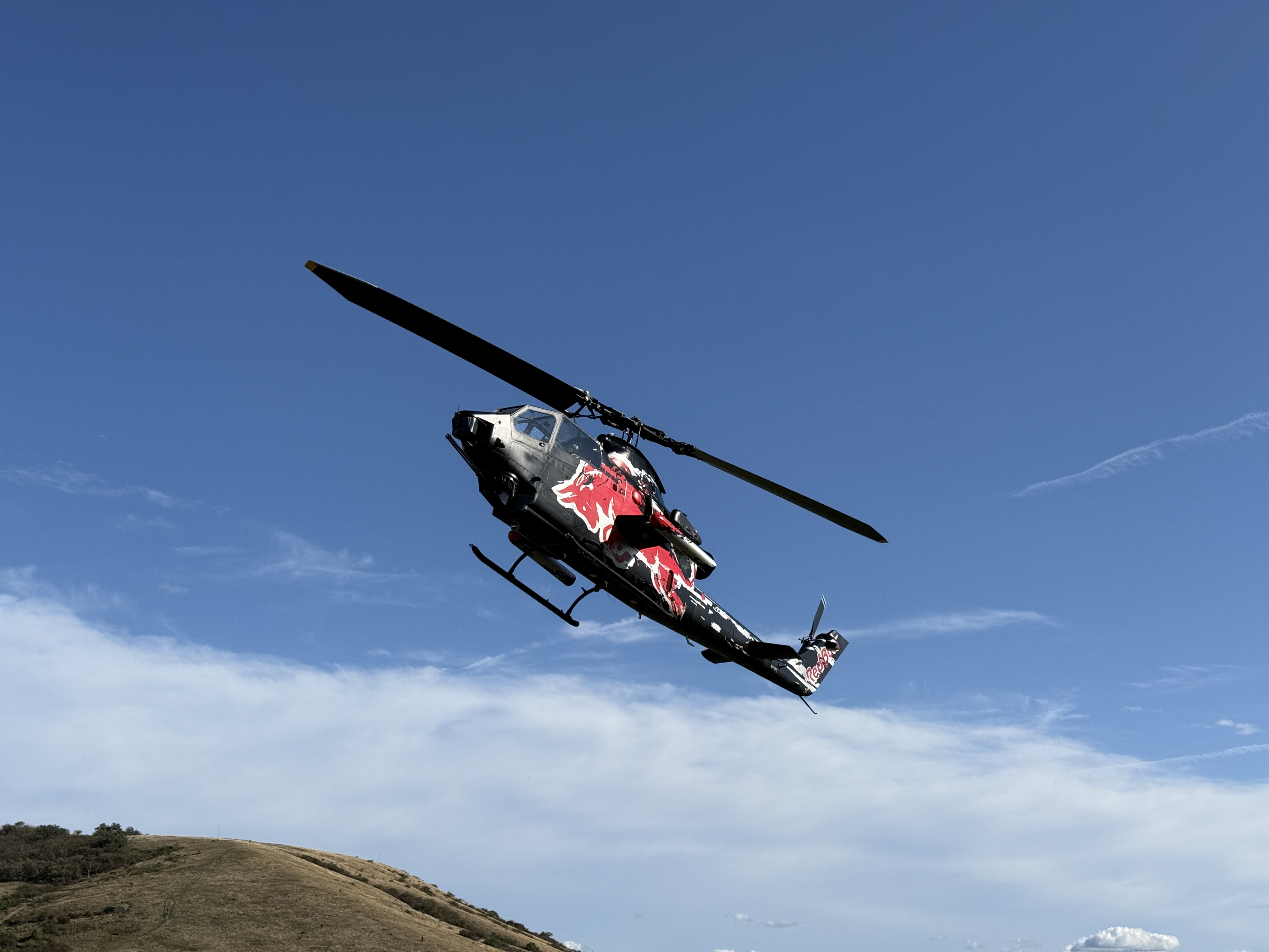helicopter flying over hill