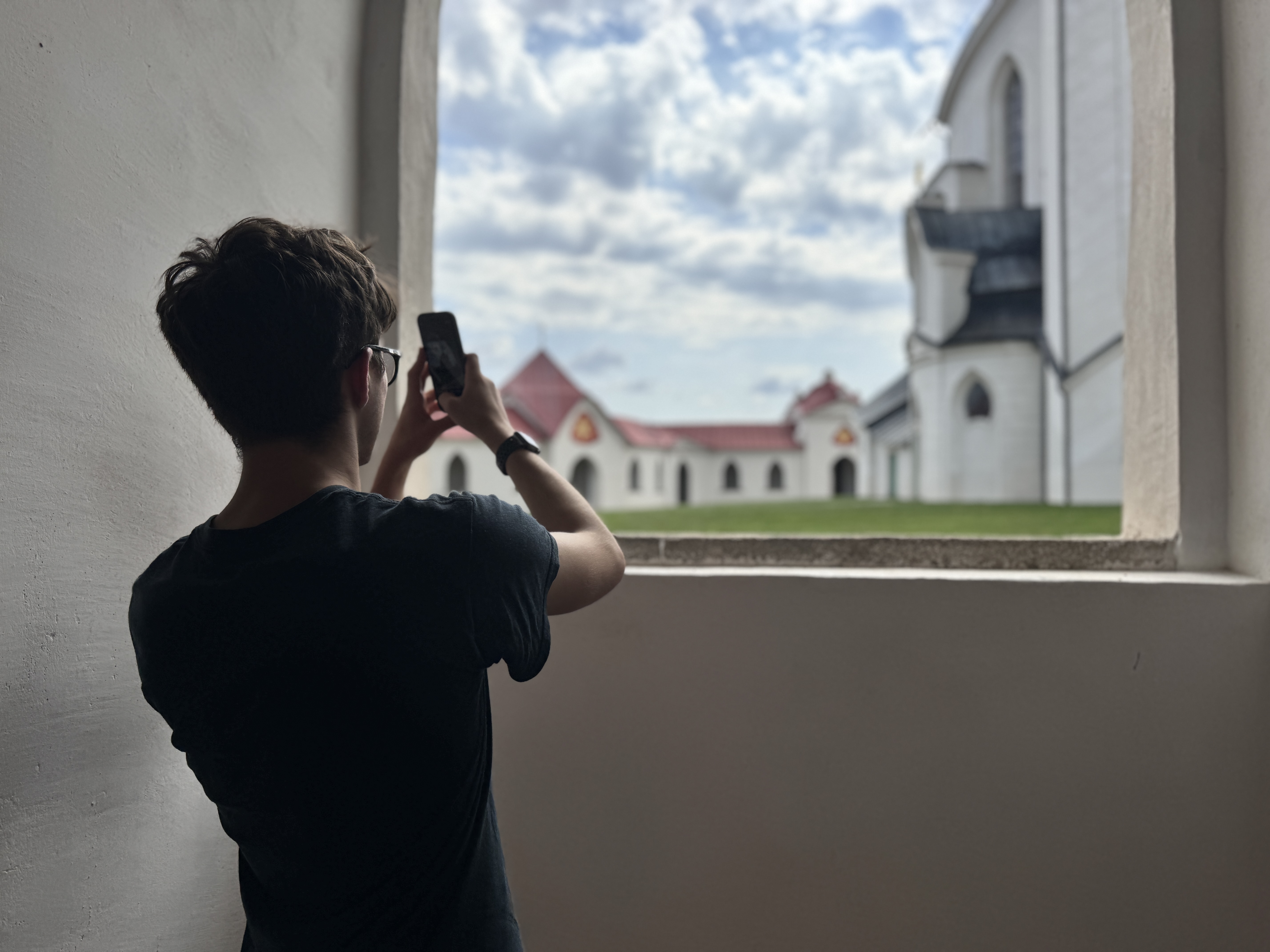 person photographing church window