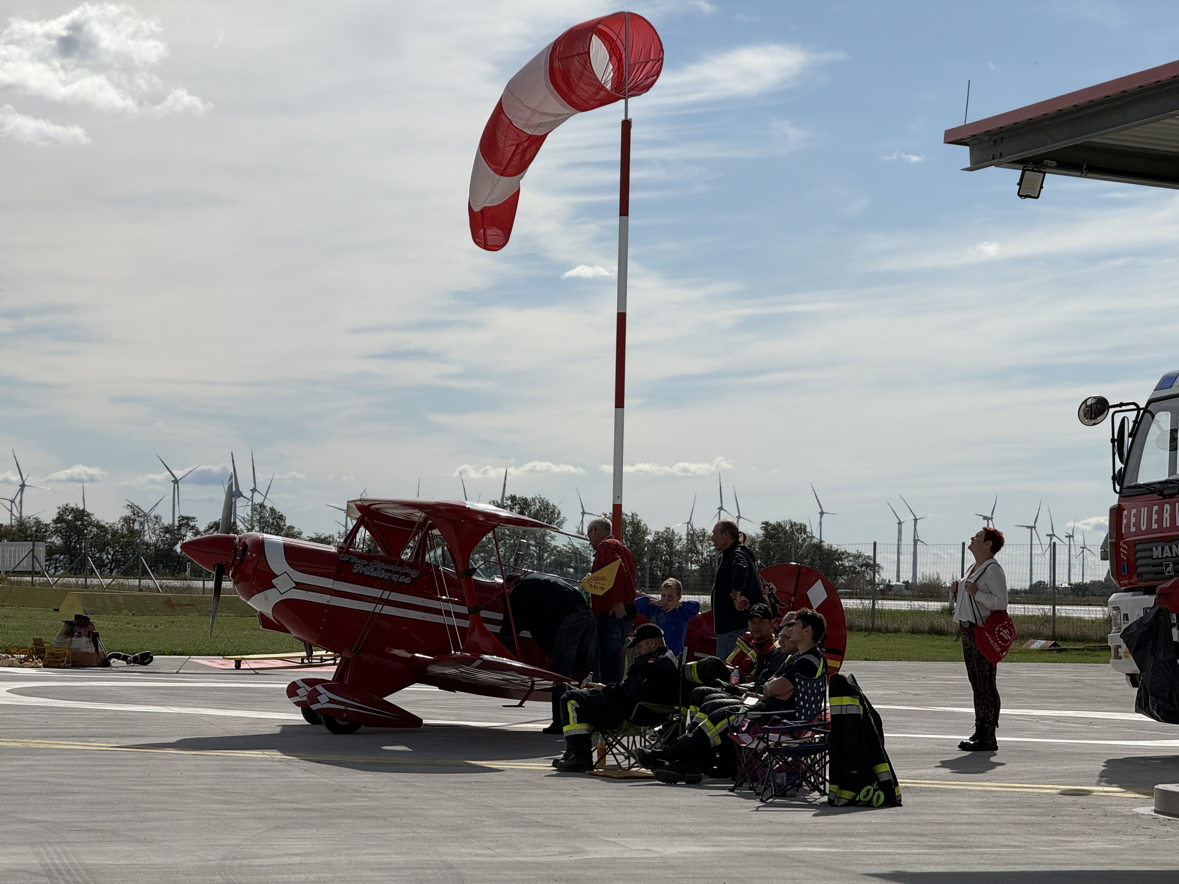 red biplane with windsock