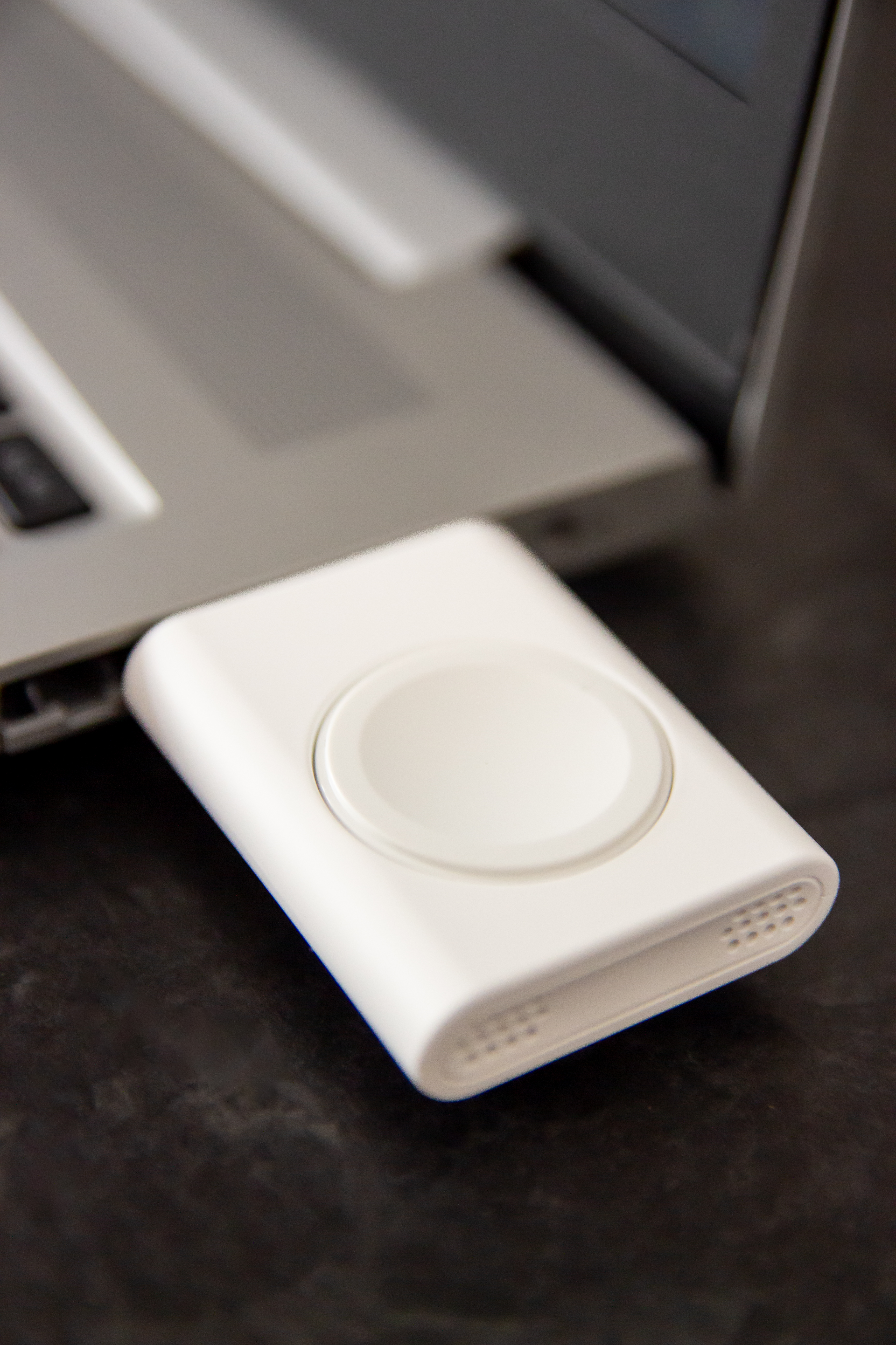 smartwatch charging on laptop