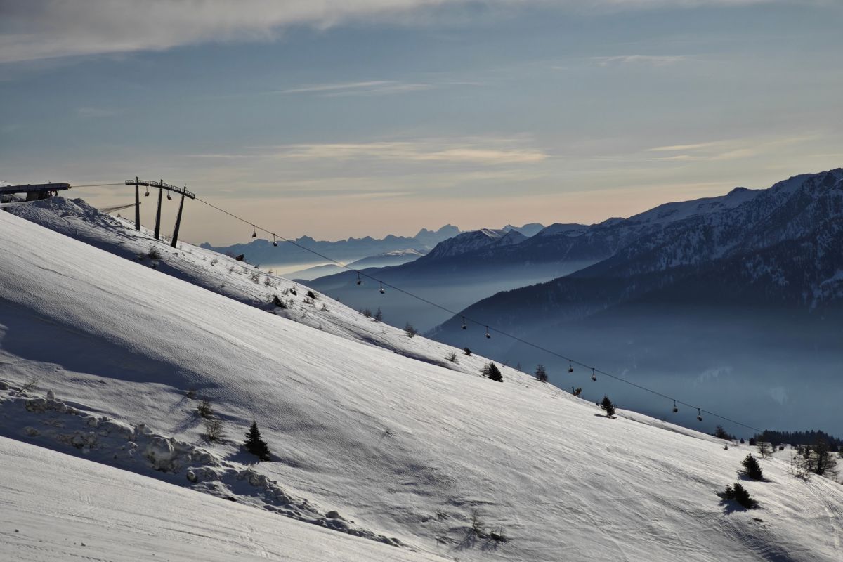 snowy mountain slope with ski lift