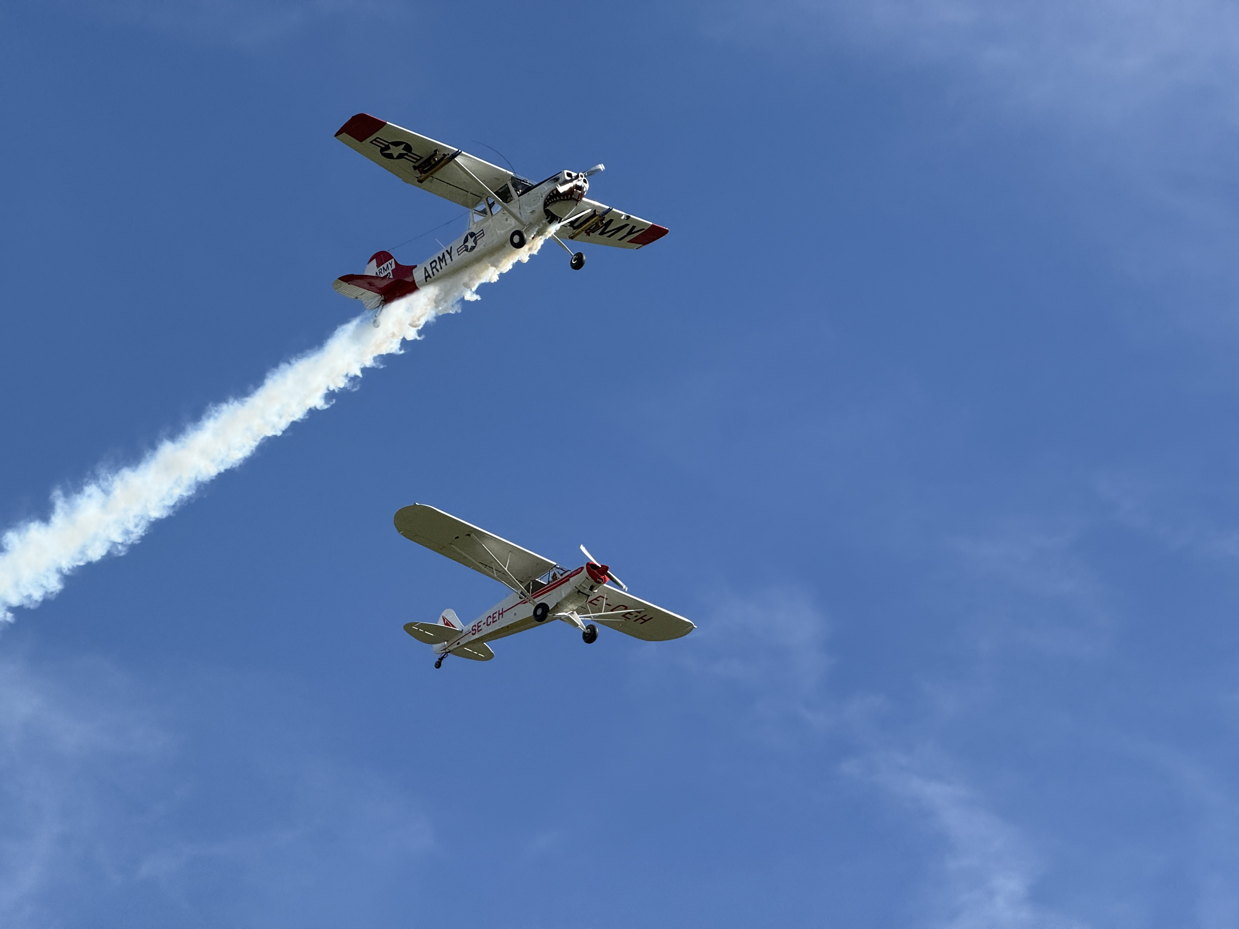 two airplanes sky smoke trail