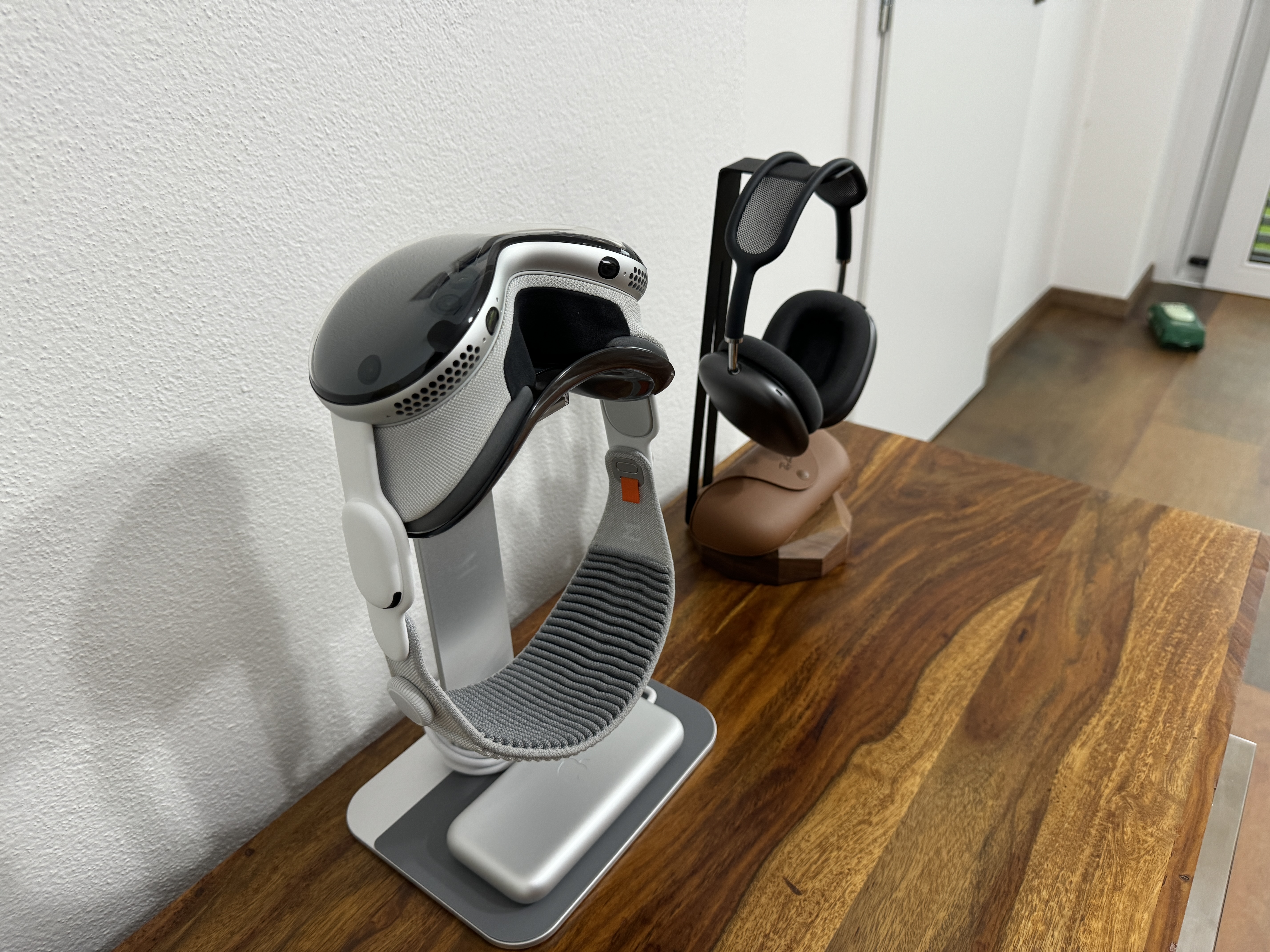 vr headset and headphones on wooden surface