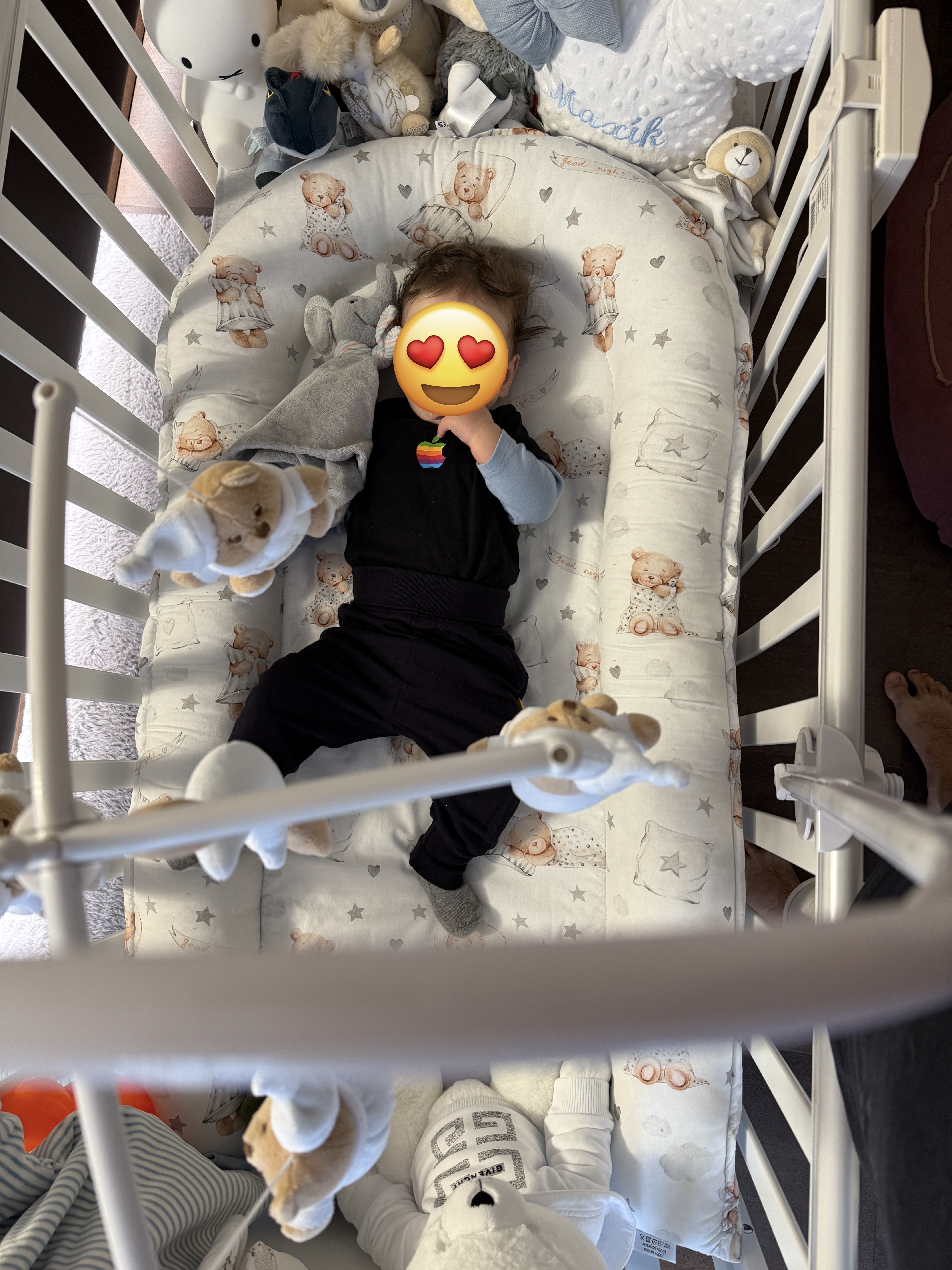 baby in crib with mobile