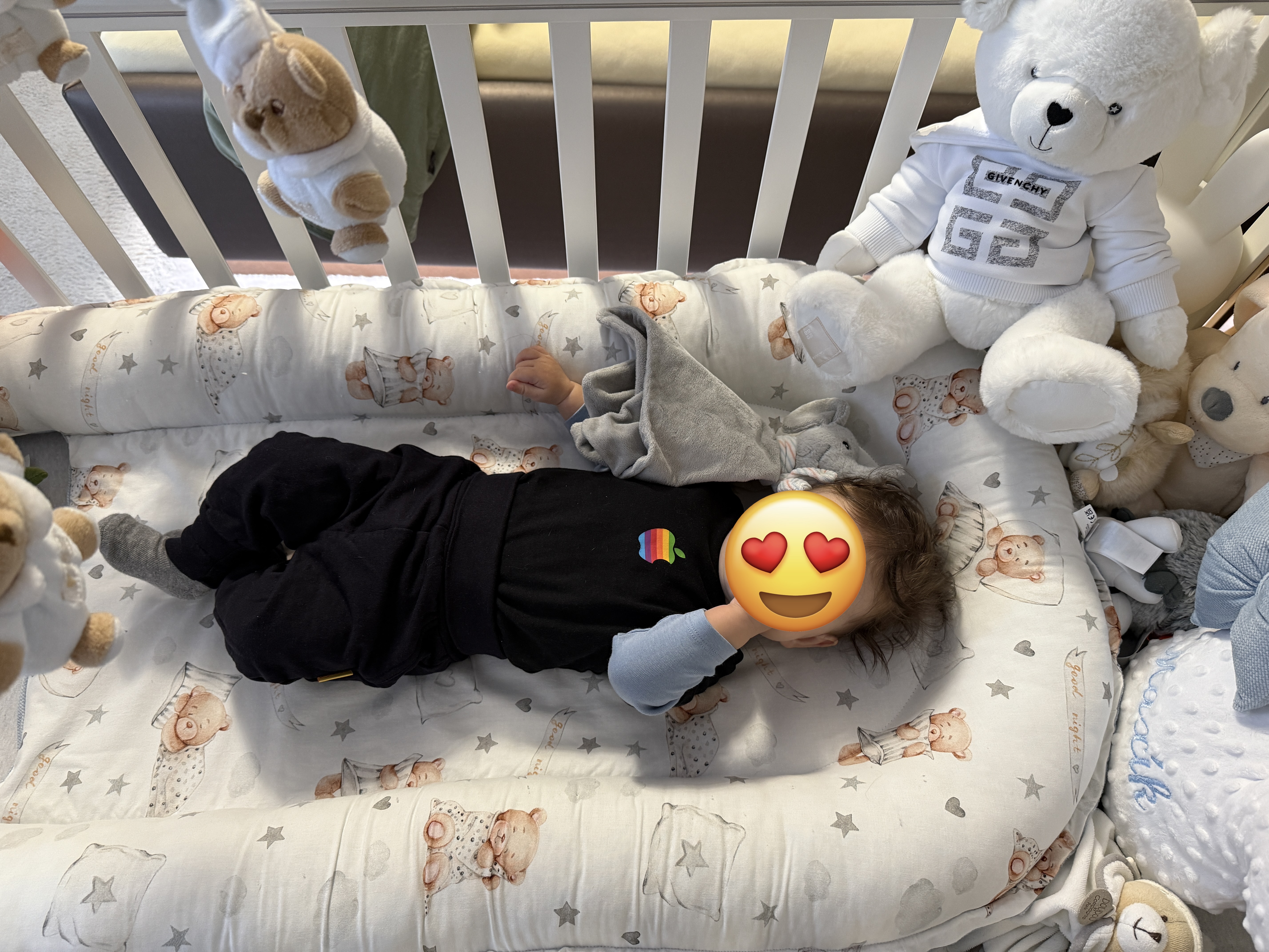 baby in crib with teddy bear