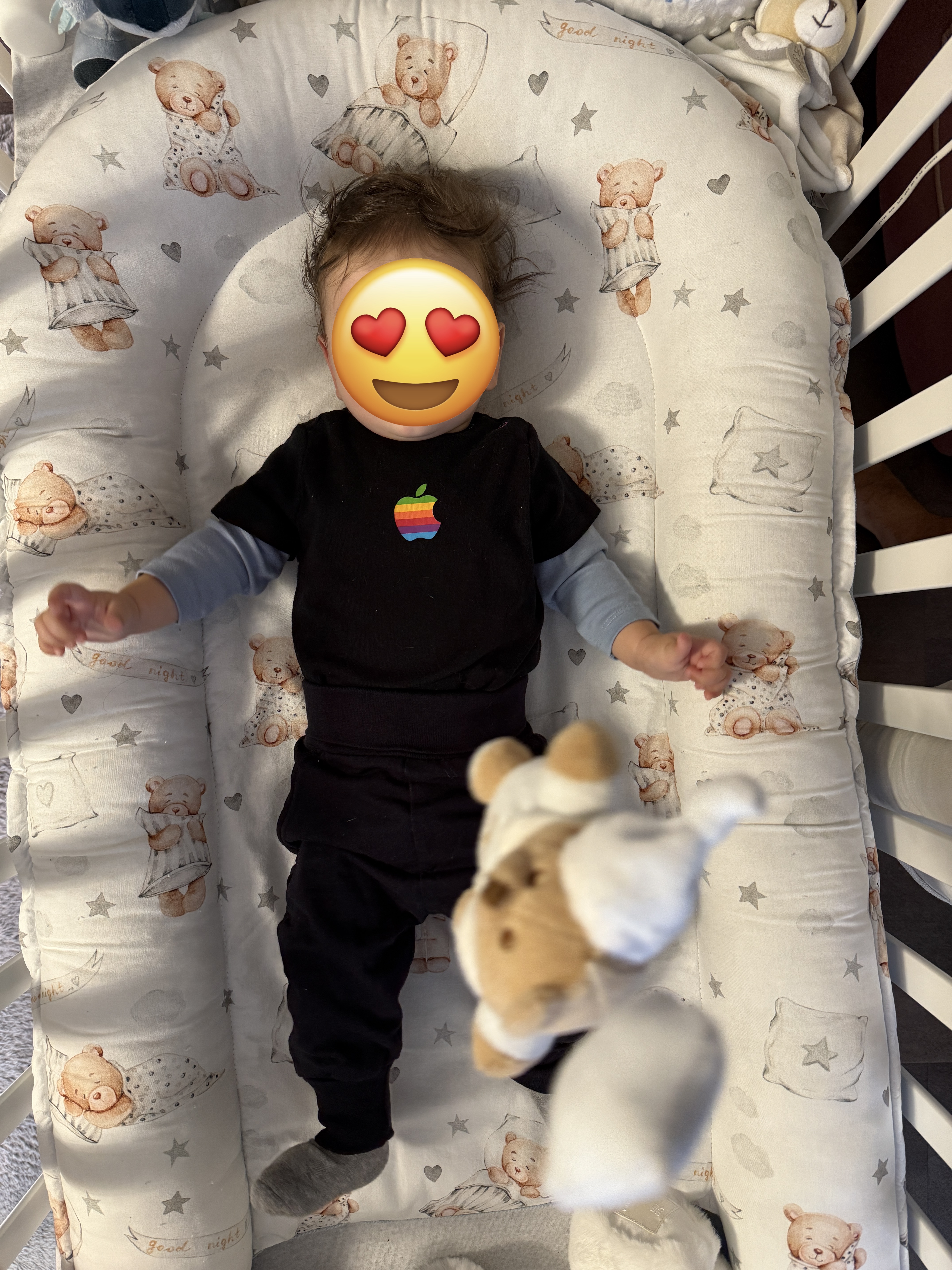 baby in crib with toys