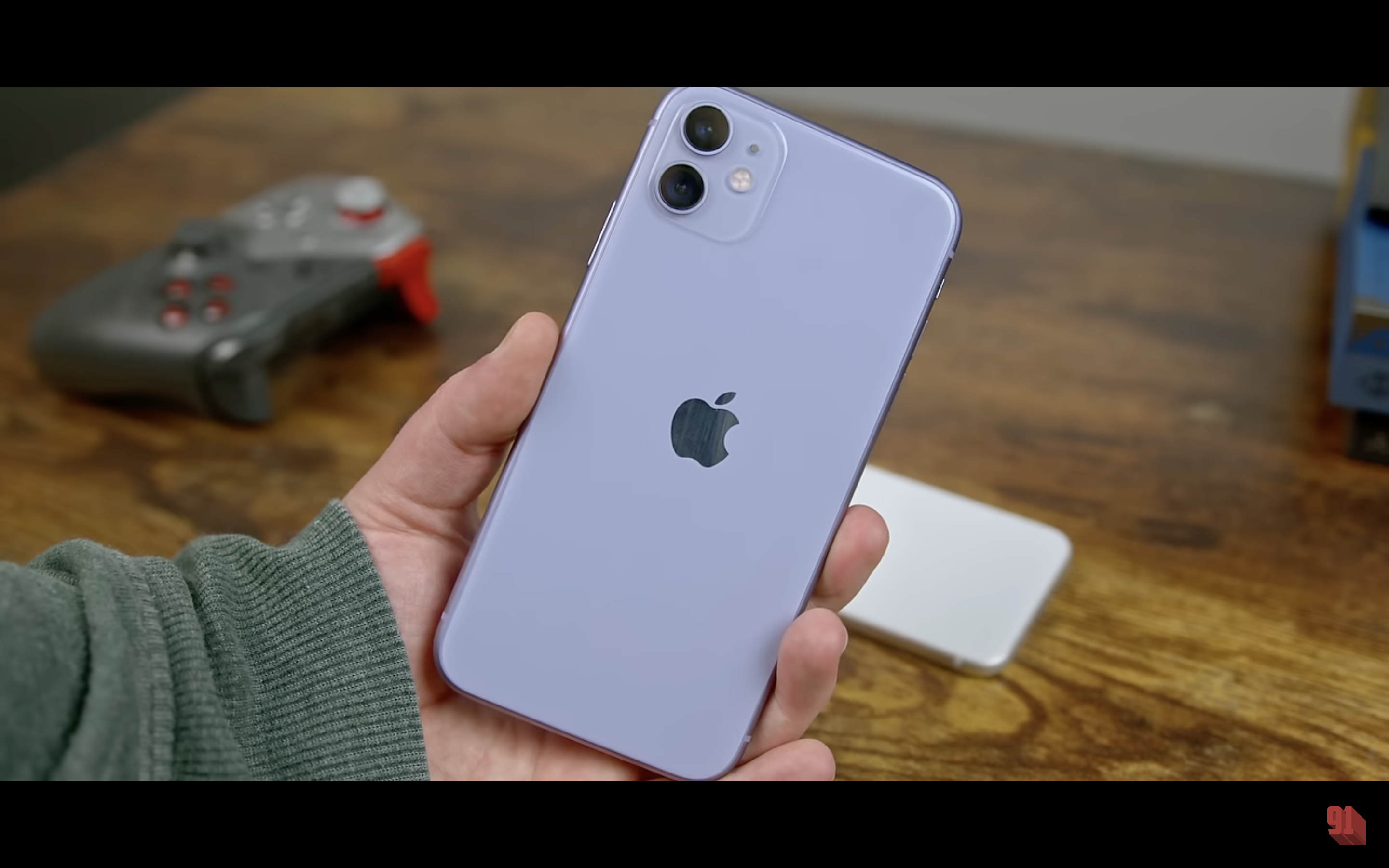 hand holding purple iphone