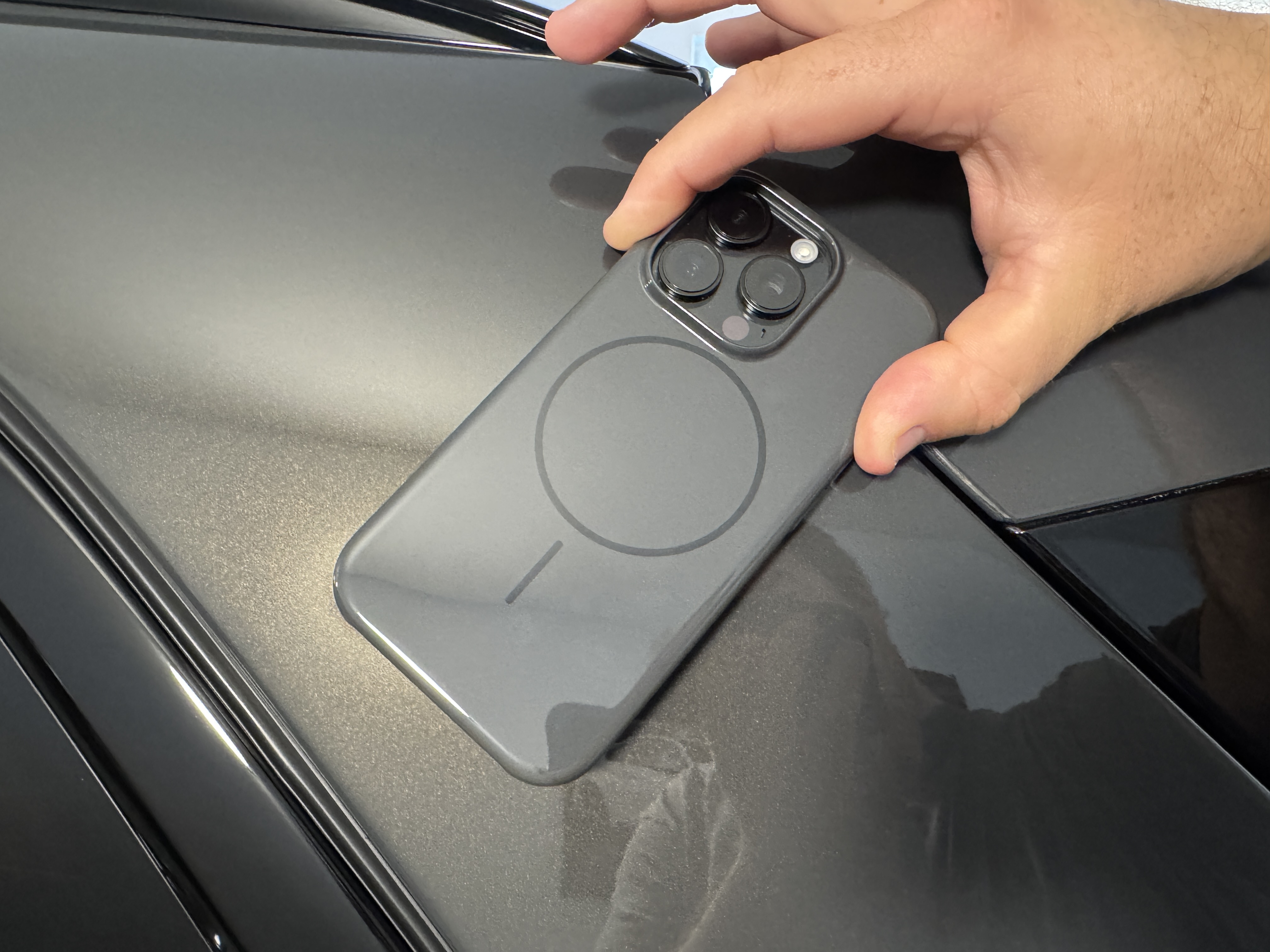 hand holding smartphone on car