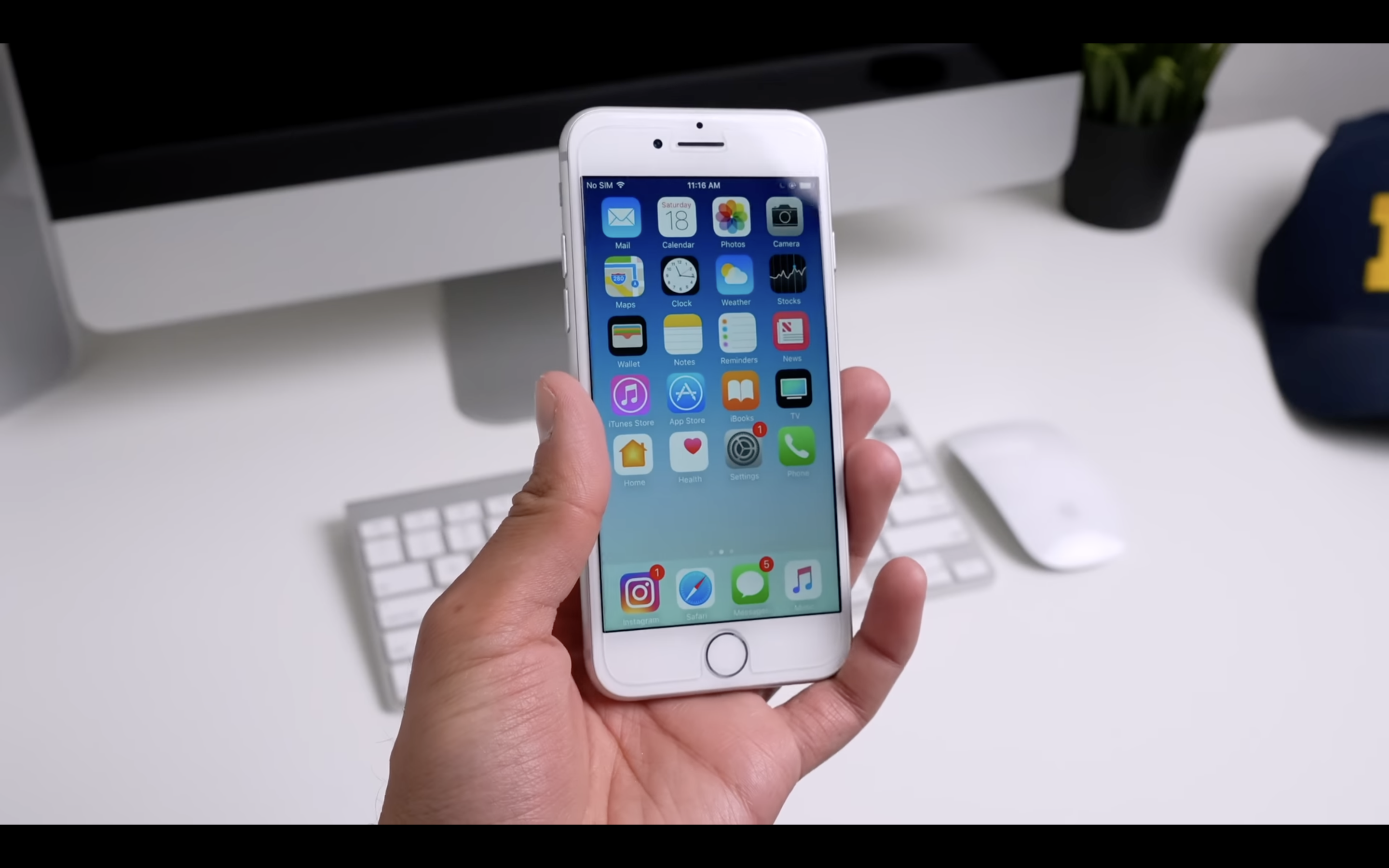 iphone in hand desk background