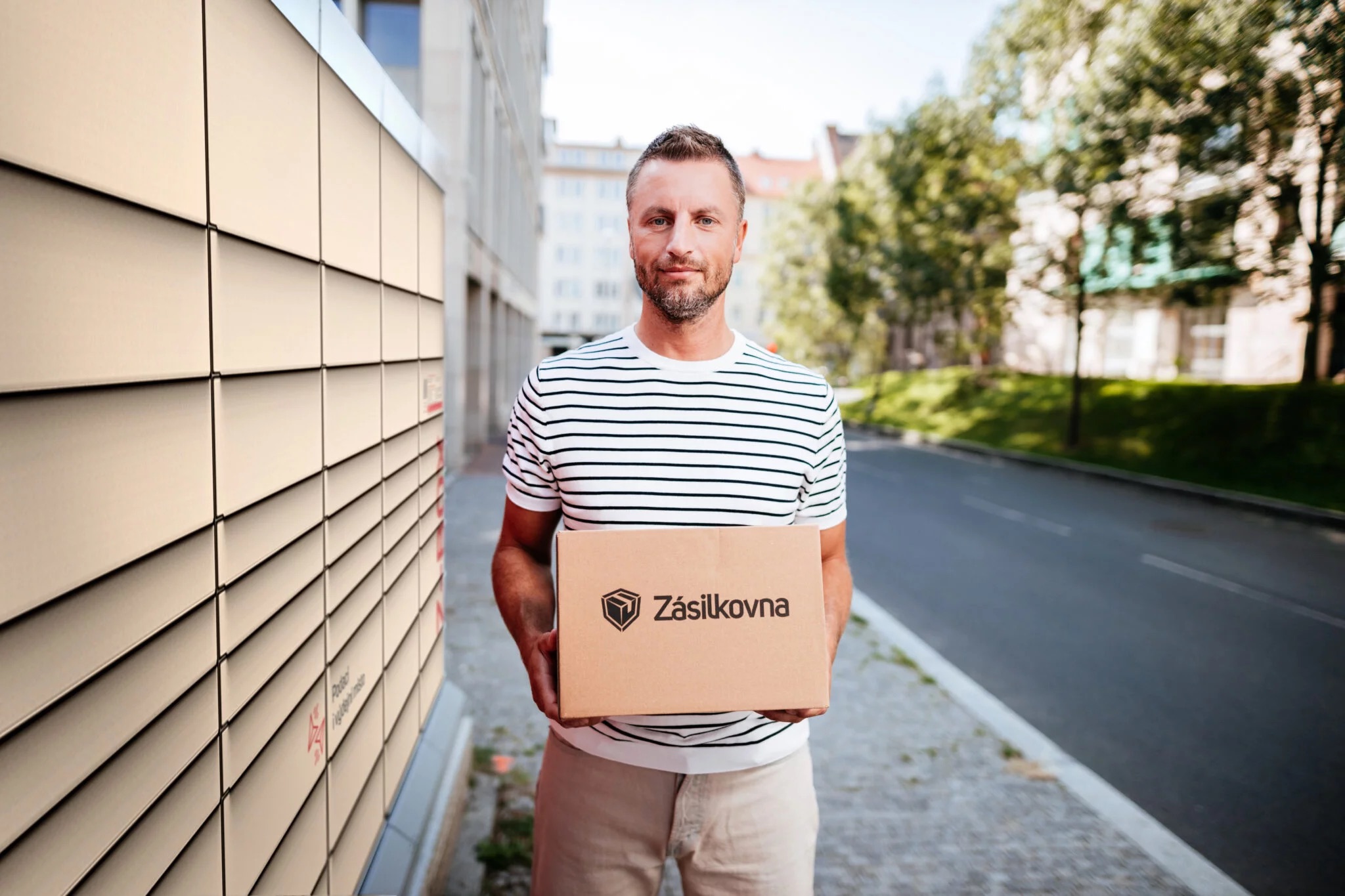 man holding package at locker