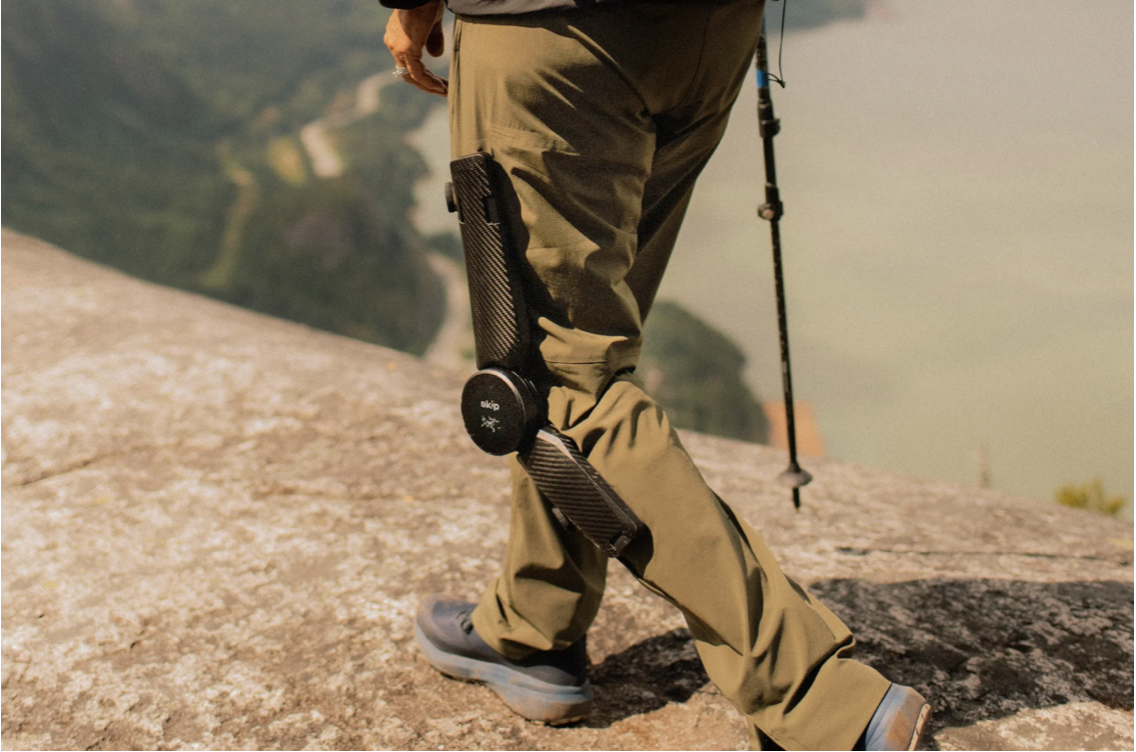 hiker with leg brace on mountain
