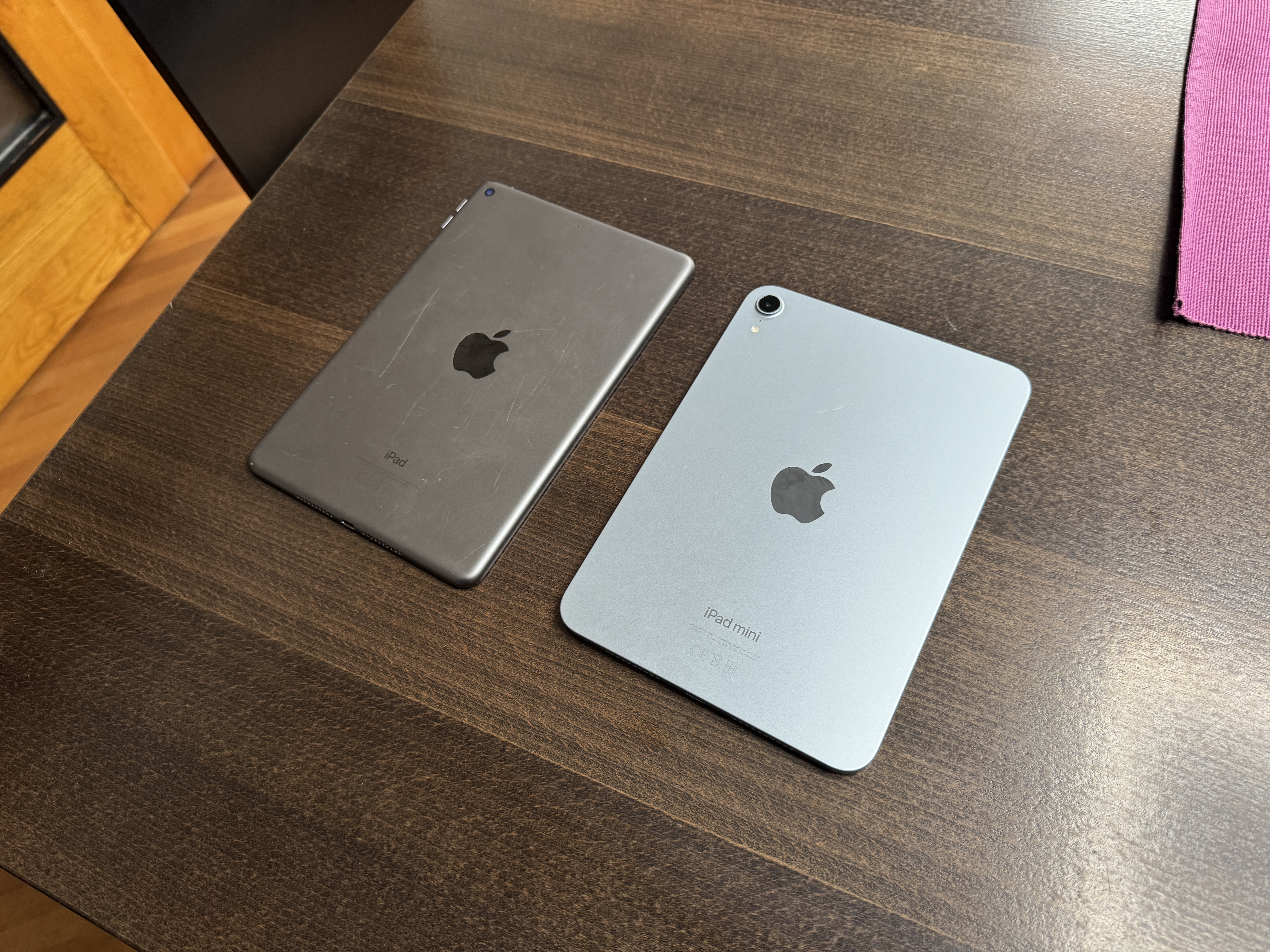 two ipads on wooden table