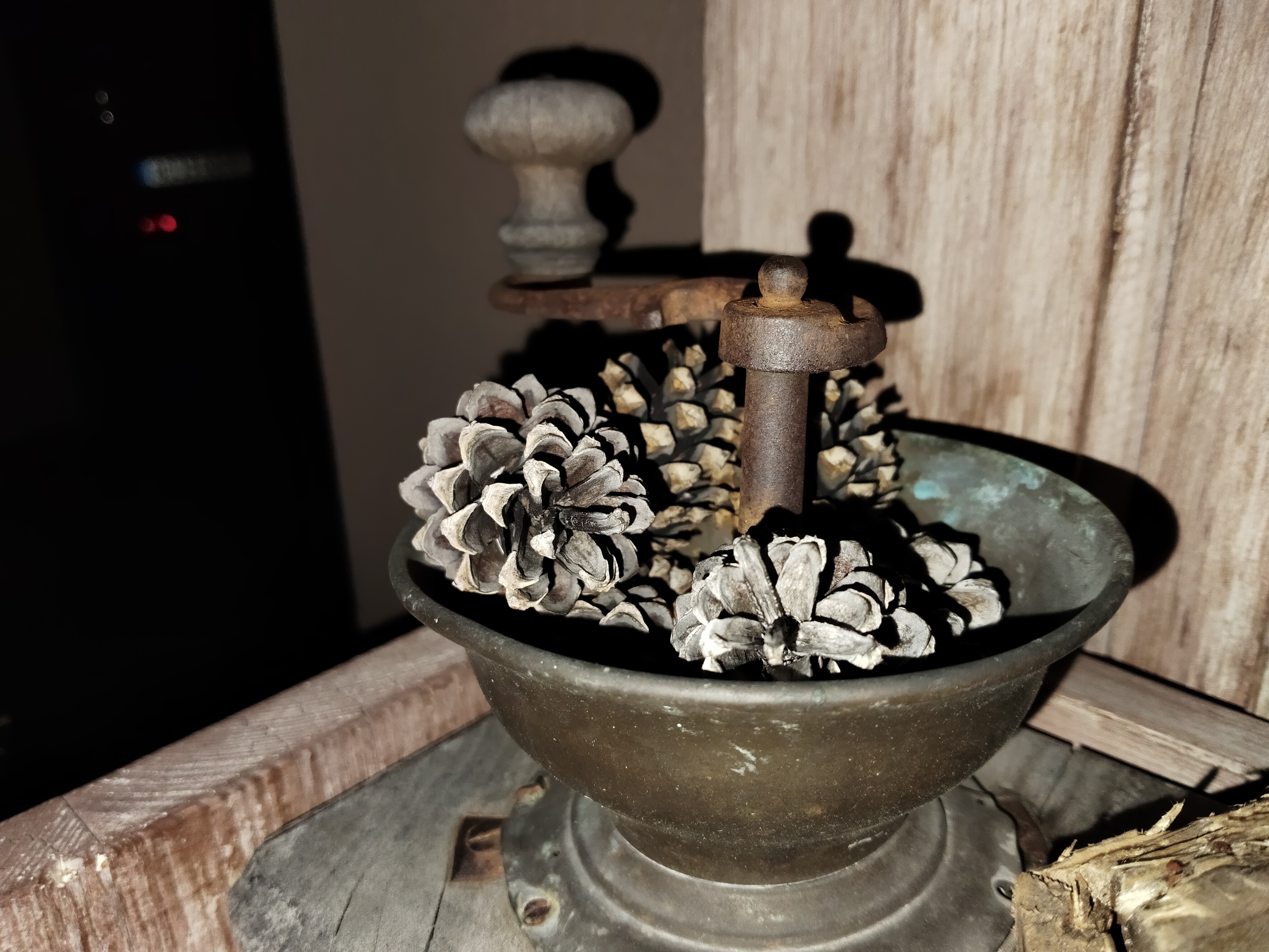 antique grinder with pinecones