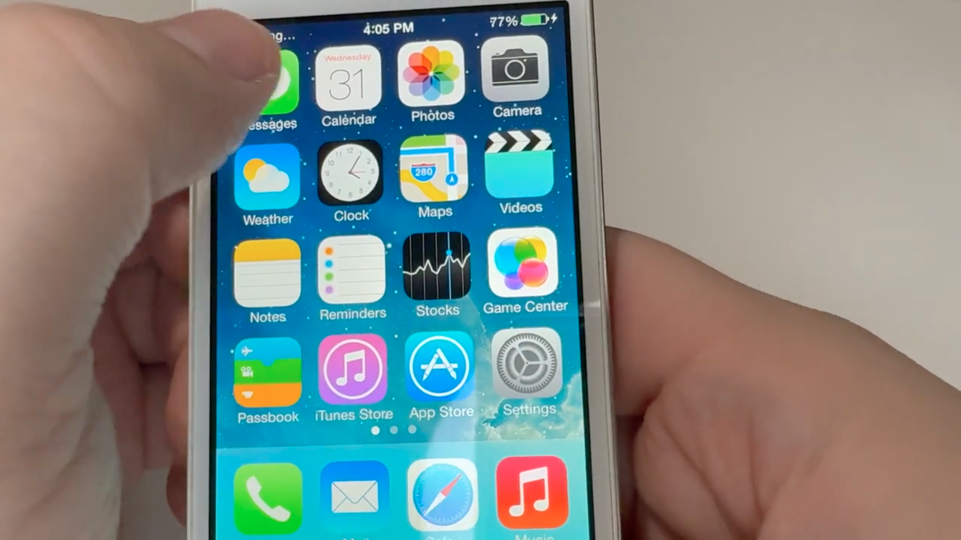 hand holding iphone home screen