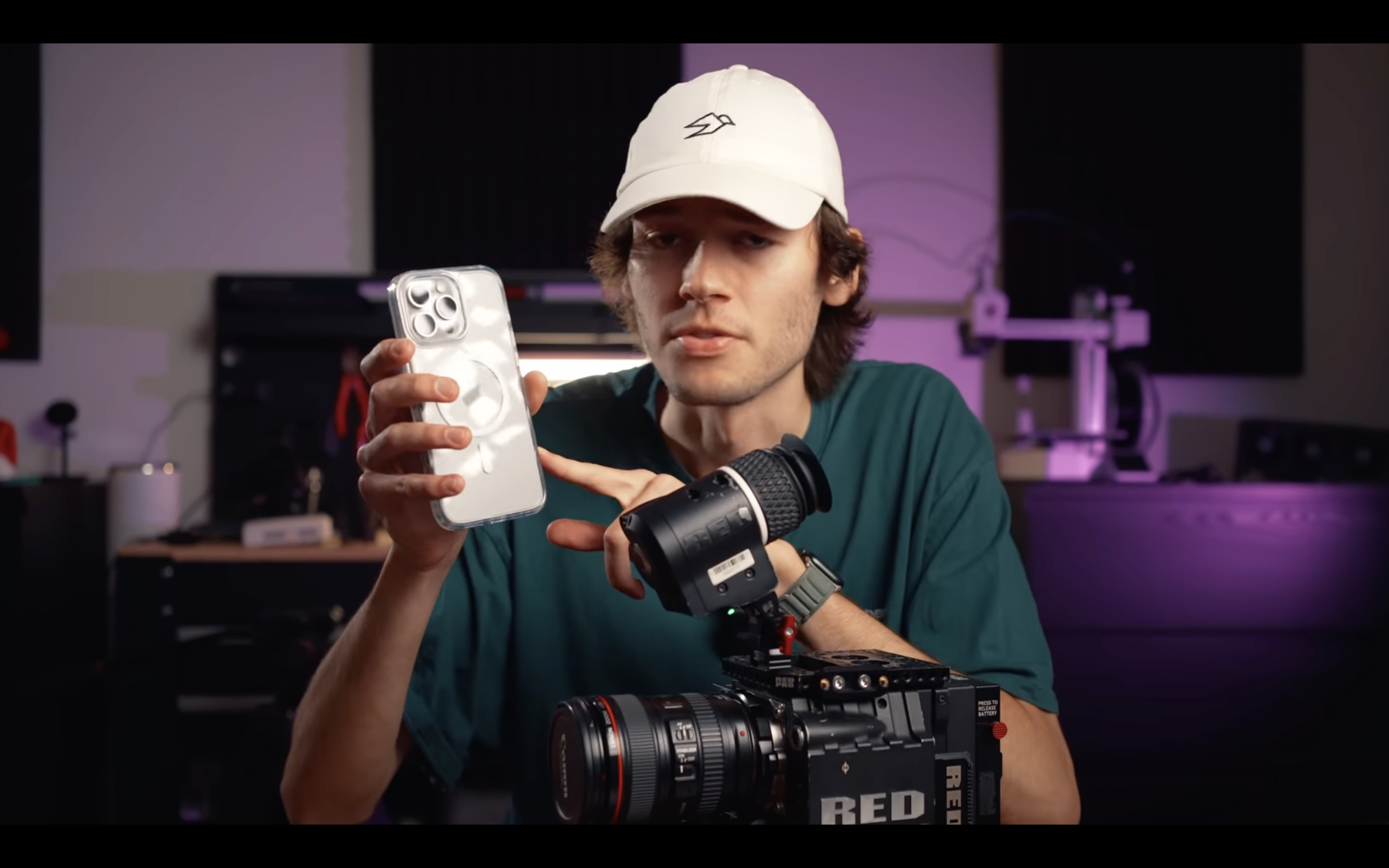 person holding iphone and camera