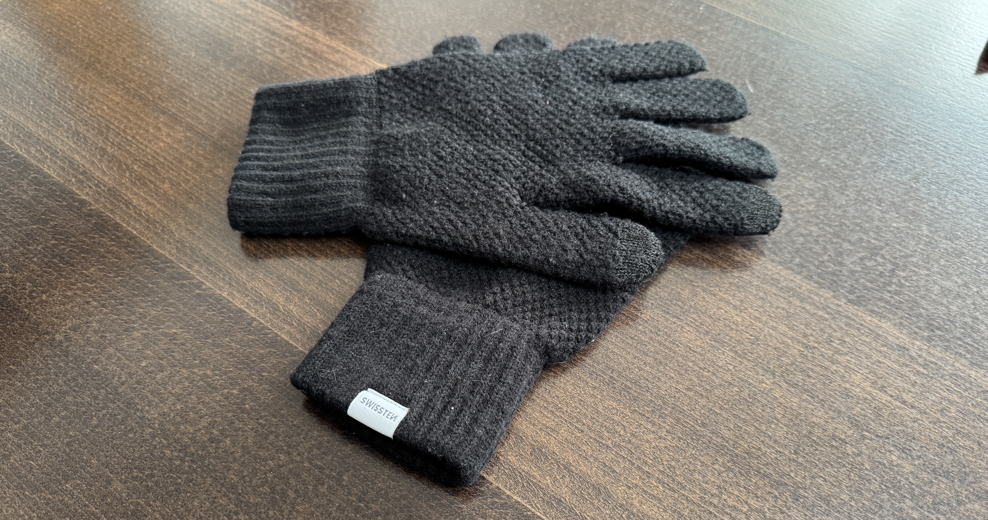 black knit gloves on table